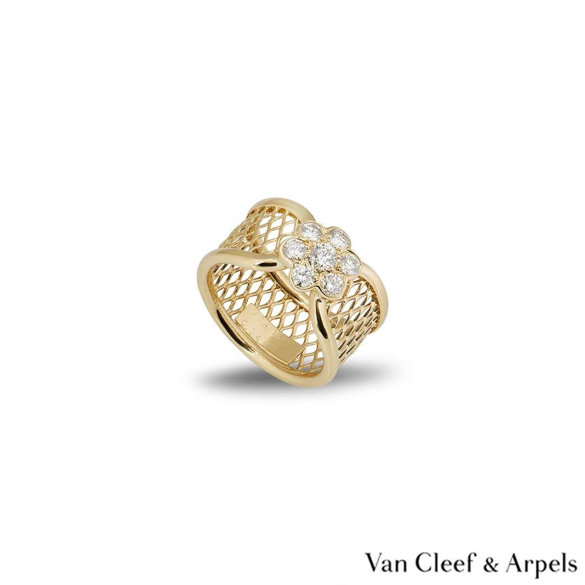 A beautiful 18k yellow gold ring from the Fleurette collection by Van Cleef & Arpels. The mesh design ring has a diamond set flower motif in the centre. There are 7 round brilliant cut diamonds totalling 0.34ct. The ring measures 1cm in width and is