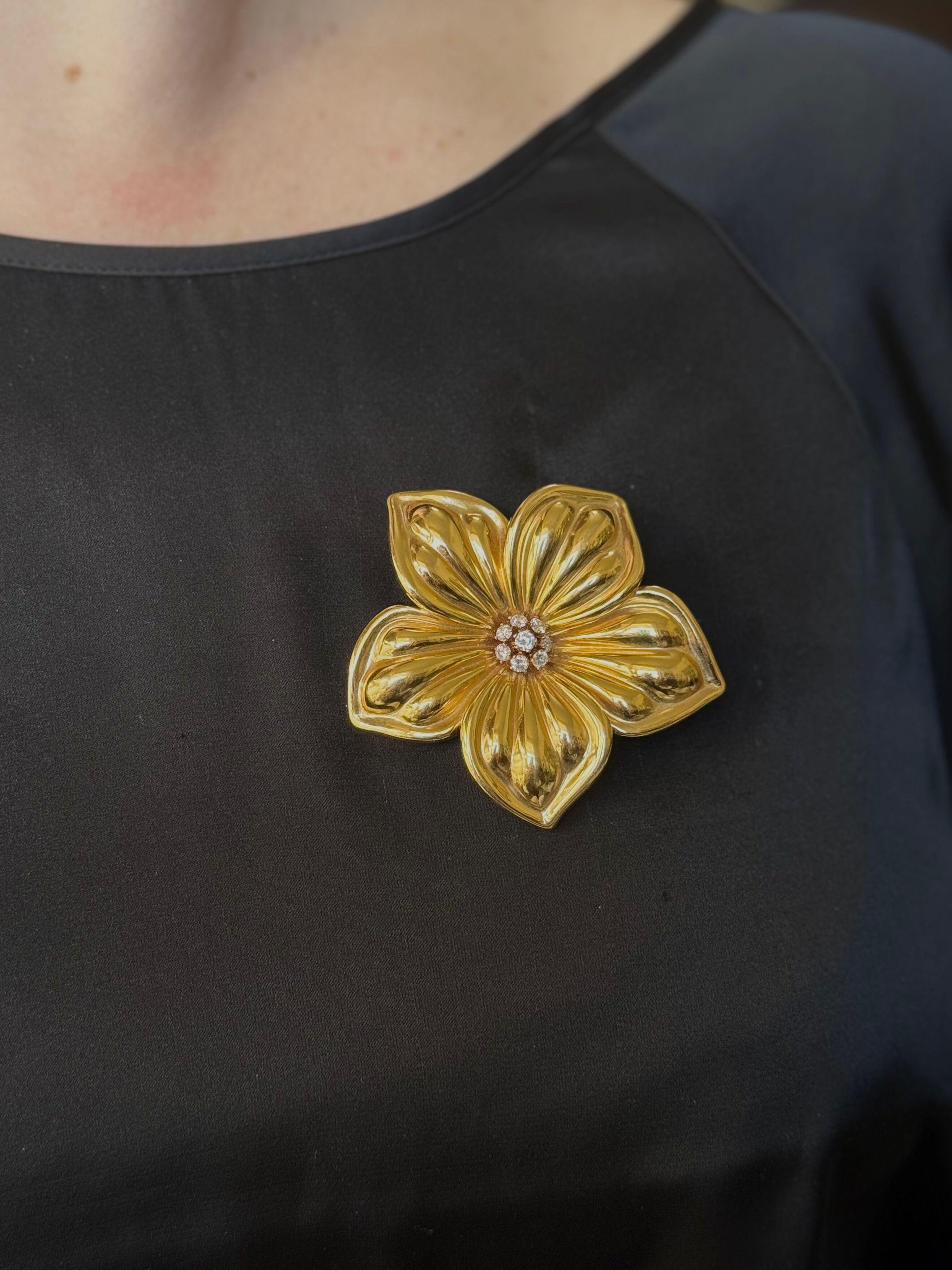 18k yellow gold flower brooch by Van Cleef & Arpels, set in the center with approx. 0.85ctw FG/VVS diamonds. 
Brooch measures 2.5