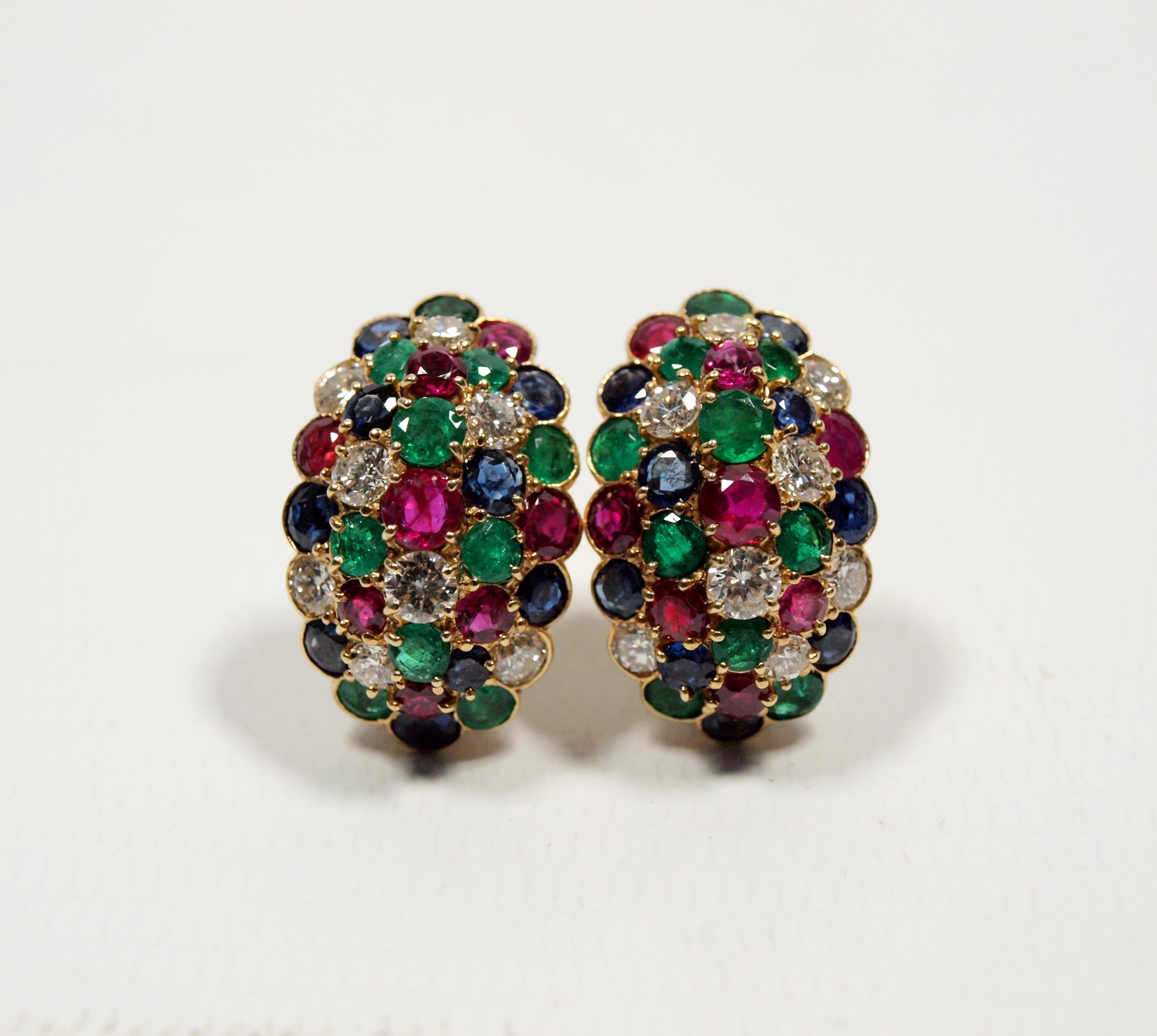 A pair of Van Cleef & Arpels yellow gold, diamond, ruby, sapphire and emerald earclips,
containing eight round brilliant cut diamonds weighing approximately 1.15 carats total, eight round mixed cut rubies measuring approximately 2.40-4.00 mm in