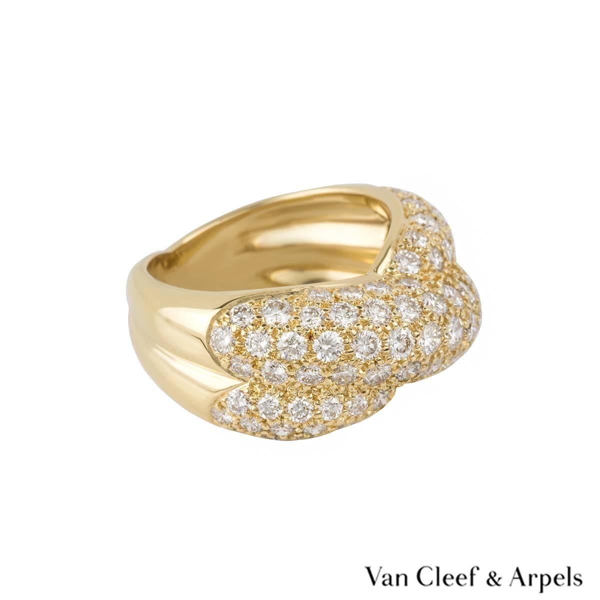 An 18k yellow gold diamond set dress ring by Van Cleef & Arpels. The ring is composed of two cross over intersections, each pave set with round brilliant cut diamonds totalling approximately 1.20ct, predominantly F/G colour and VS2 in clarity. The