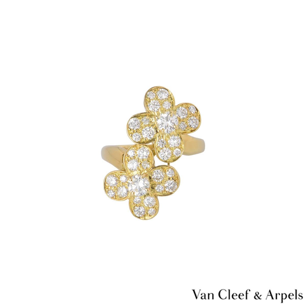 A beautiful 18k yellow gold Van Cleef & Arpels diamond ring from the Trefle collection. The ring comprises of a double 4 petal flower motifs with a round brilliant cut diamond in the centre of each. Complementing the motif are 32 round brilliant cut