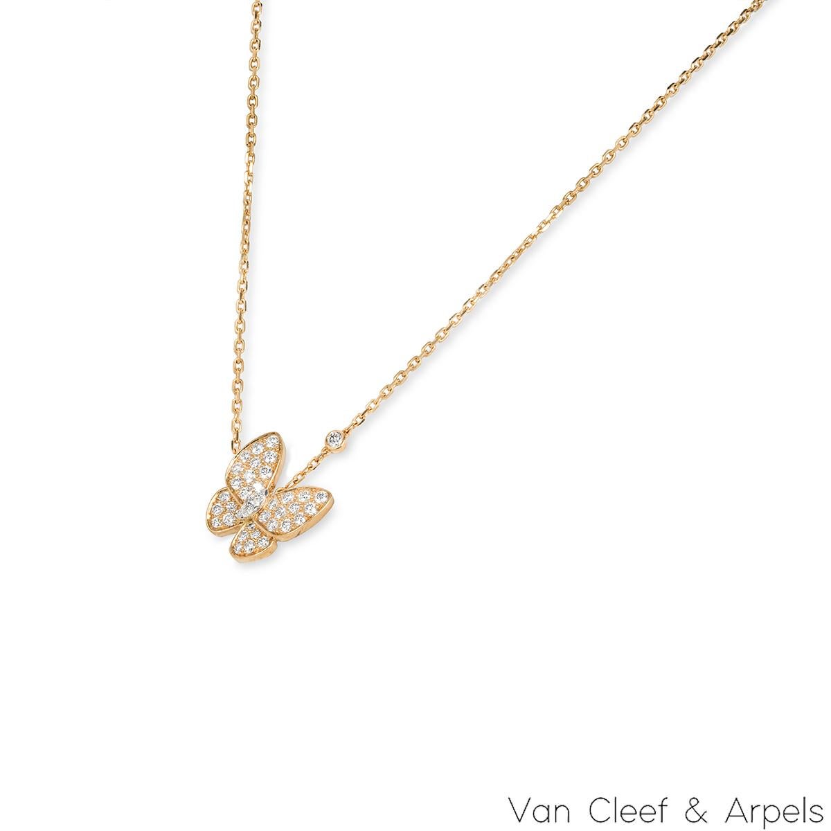 A charming 18k yellow gold diamond pendant by Van Cleef & Arpels from the Two Butterfly collection. The pendant features a butterfly motif set to the centre with marquise cut diamond, a single bezel set diamond on the chain and 34 round brilliant