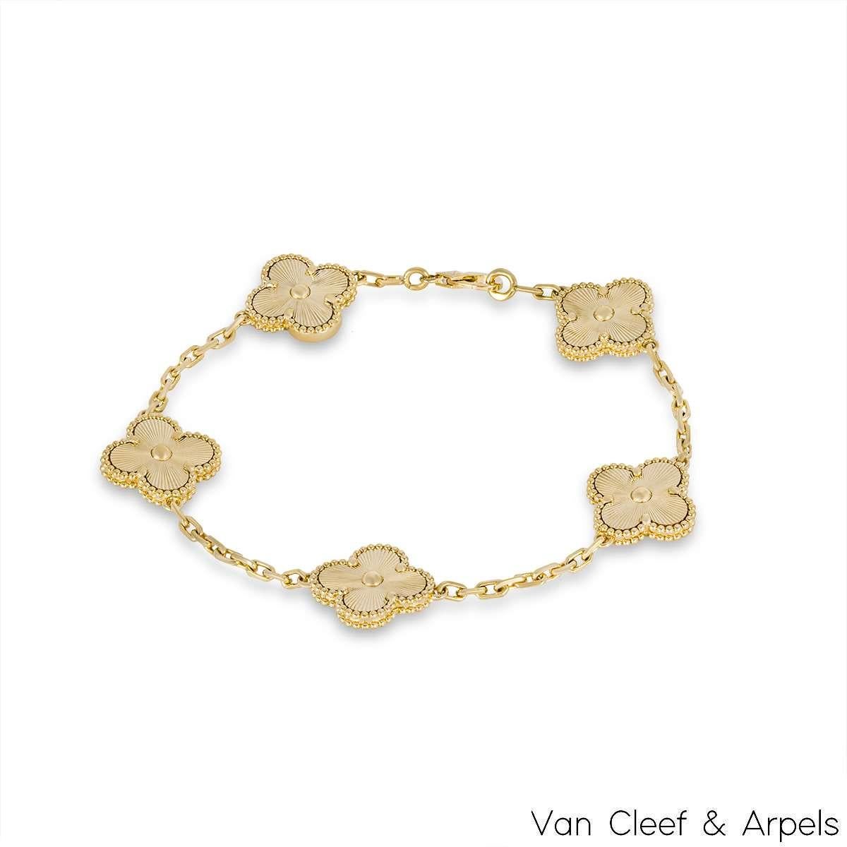 A stunning 18k yellow gold, guilloche bracelet from the Vintage Alhambra collection by Van Cleef and Arpels. The bracelet is made up of 5 of the iconic clover motifs, each set with a beaded edge and a guilloche inlay. Measuring 7.5 inches in length,
