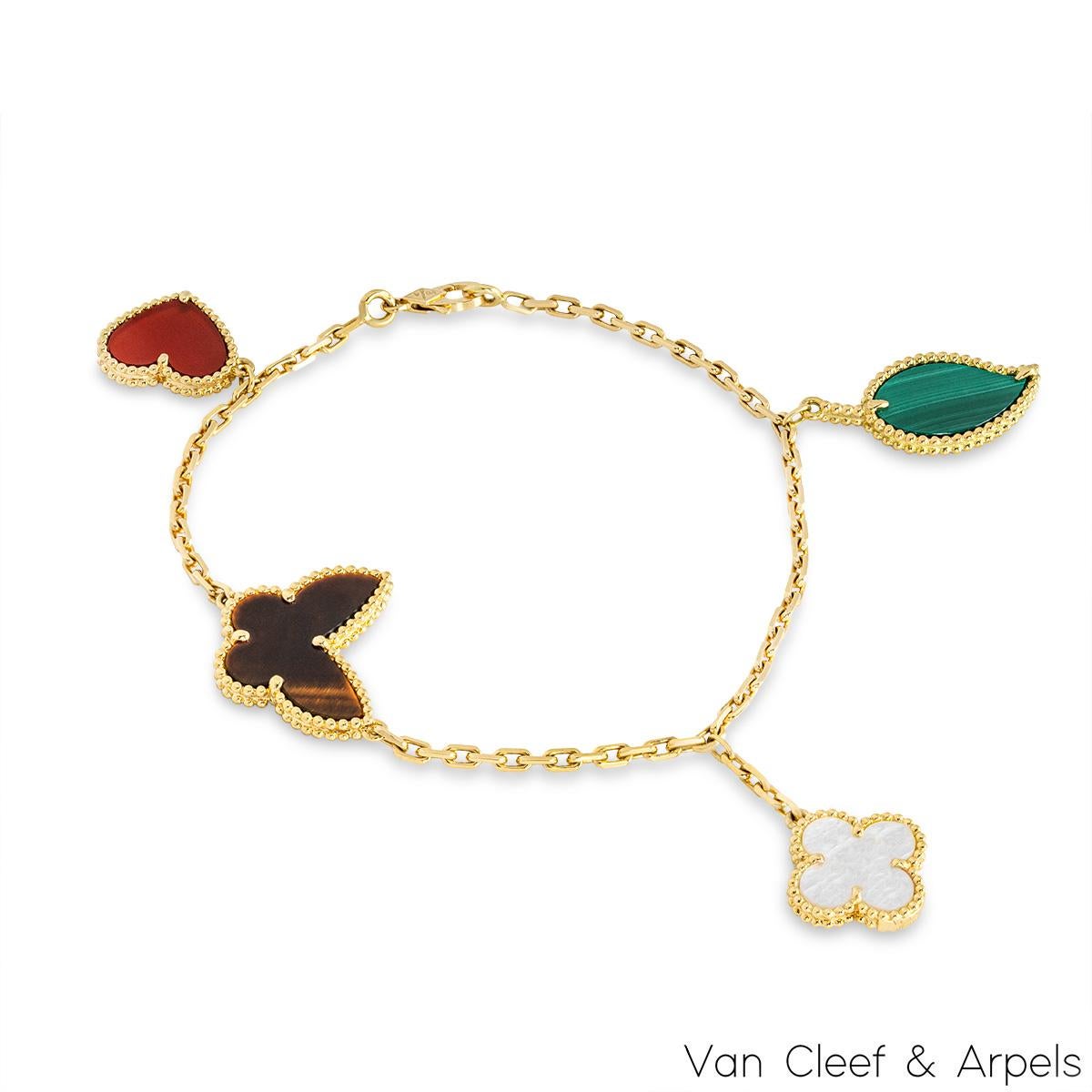 A lovely 18k yellow gold, Lucky Alhambra bracelet by Van Cleef & Arpels. The bracelet features a malachite leaf motif, a mother of pearl clover motif, a tiger's eye butterfly motif and a carnelian heart motif. Measuring 7.5 inches in length, the