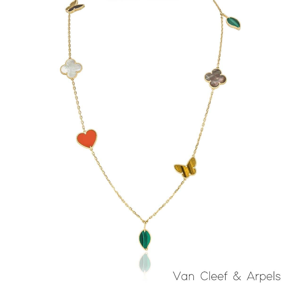 A beautiful 18k yellow gold, Lucky Alhambra long necklace by Van Cleef & Arpels. Features 12 motifs, with an array of motifs including hearts, butterflies, leaves and the iconic clovers. The motifs are set with carnelian, malachite, mother of pearl