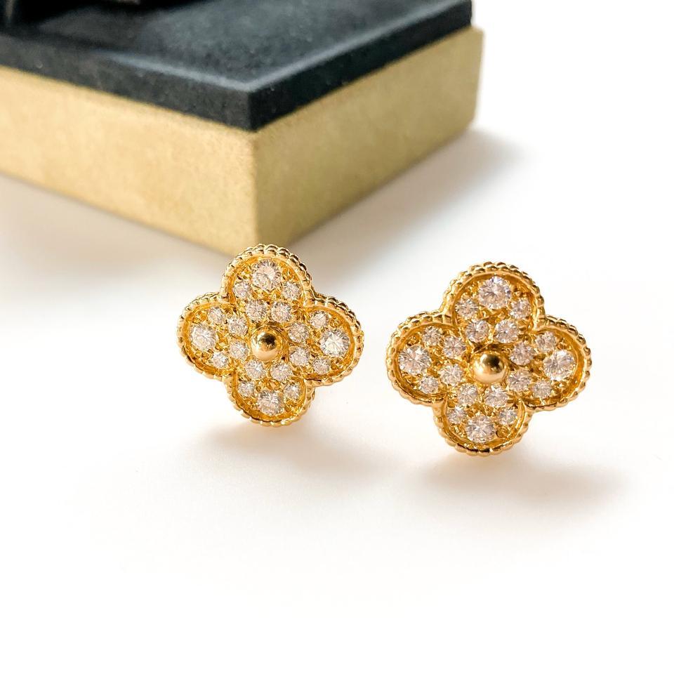 Luxury and the beauty of nature meet with this stunning Van Cleef & Arpels 18k Gold and Diamonds Magic Alhambra Earrings. This emblematic and celebrated clover shaped earrings have been a favorite among fans and is made of gorgeous 18k yellow gold