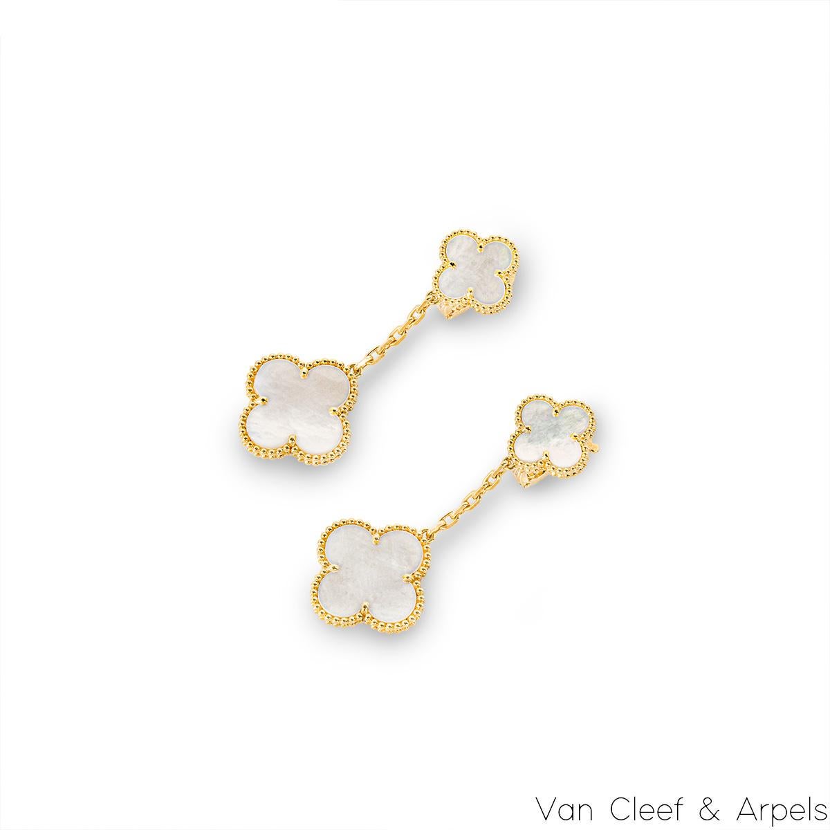 A gorgeous pair of 18k yellow gold mother of pearl earrings by Van Cleef & Arpels from the Magic Alhambra collection. The earrings comprise of two graduating 4-leaf clover motifs with a mother of pearl inlay, complemented by a beaded edge and