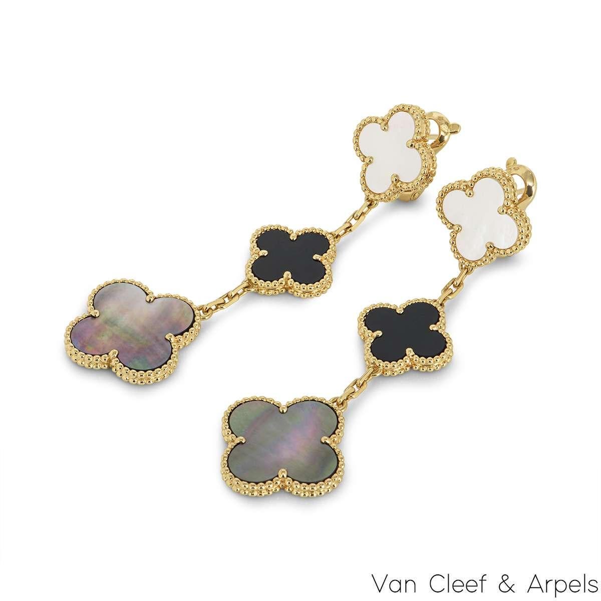 An iconic pair of 18k yellow gold earrings by Van Cleef & Arpels, from the Magic Alhambra collection. Comprising of 3 four-leaf clover motifs alternating in size complemented by a beaded outer edge, each individually set with onyx and white and grey