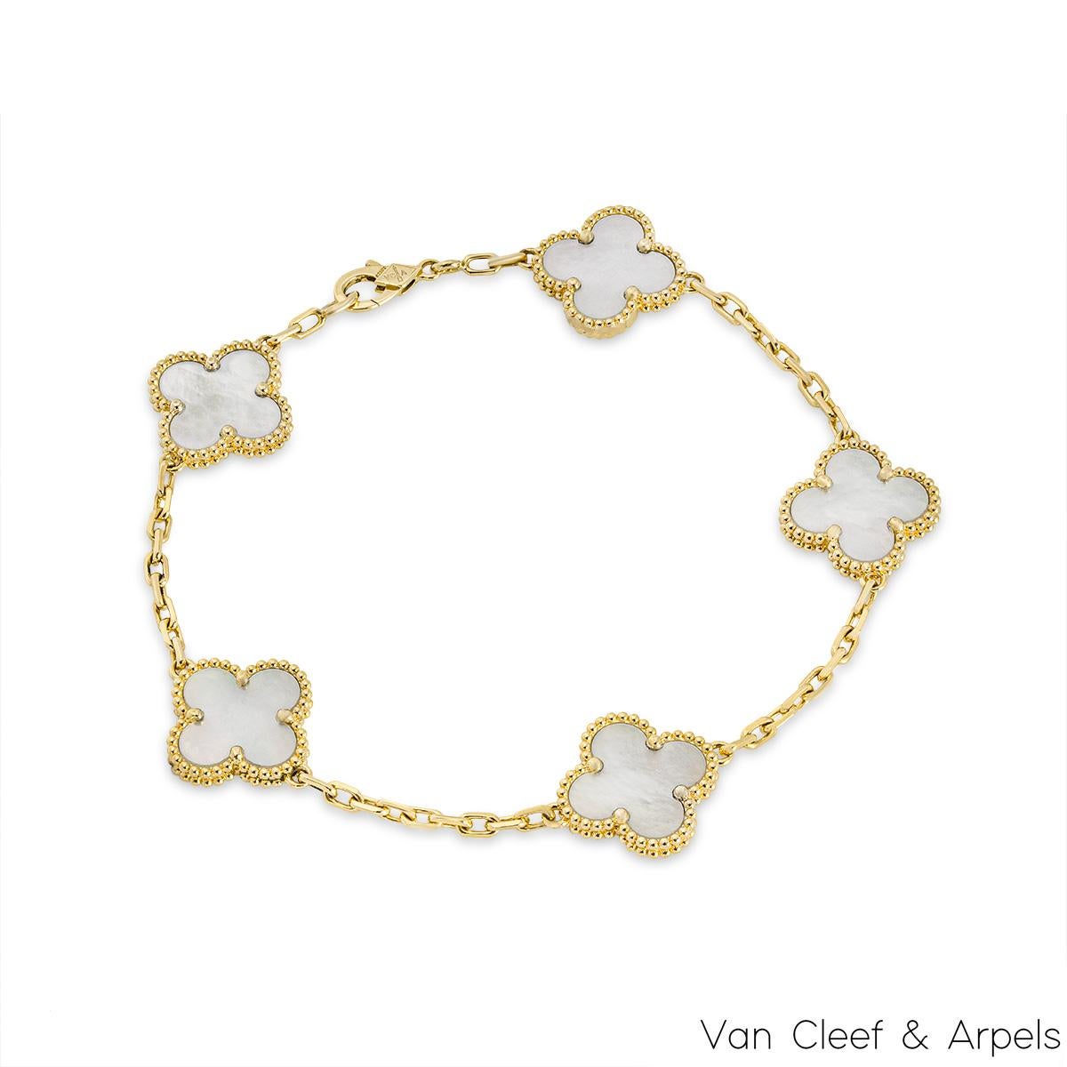 A gorgeous 18k yellow gold mother of pearl bracelet by Van Cleef and Arpels from the Vintage Alhambra Collection. The stylish bracelet is made up of 5 iconic 4 leaf clover motifs, each set with a mother of pearl inlay and finished with a beaded