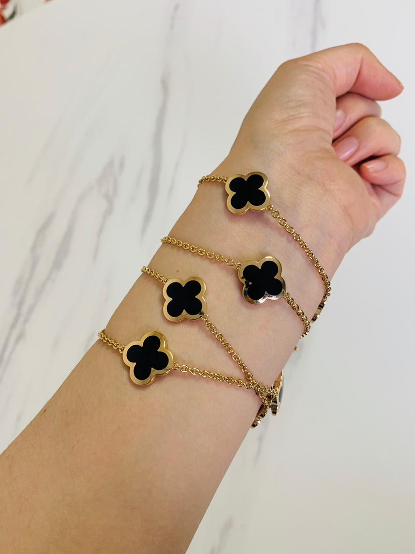 An 18k yellow gold Pure Alhambra necklace by Van Cleef & Arpels. The necklace is composed of 14 iconic four-leaf clover motifs, set to the center with onyx inlays and a polished outer edge. 

Van Cleef & Arpels Pure 14 Motif Alhambra is a very rare