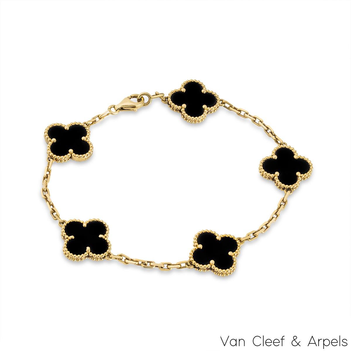 A timeless 18k yellow gold onyx bracelet from the Vintage Alhambra collection by Van Cleef and Arpels. The bracelet is made up of 5 iconic clover motifs, each set with a beaded edge and a black onyx inlay, set throughout the length of the chain. The