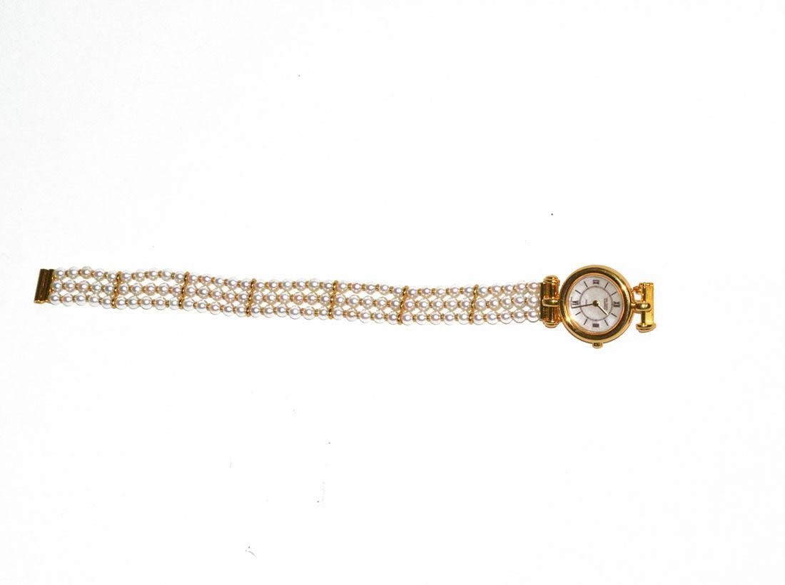 Elegant! 18K yellow gold (VCA) Van Cleef watch, currently on a multi strand pearl bracelet, but this band is detachable, and there are 3 other bands you can interchange. Watch is running and in new condition, with a Swiss quartz movement and comes