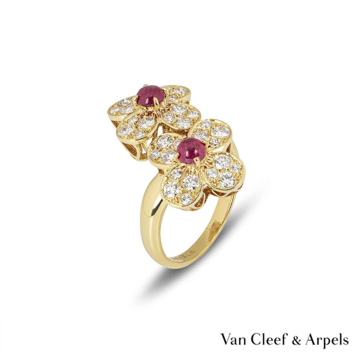 A beautiful 18k yellow gold Van Cleef & Arpels ring from the Trefle collection. The ring comprises of two flower motifs, with a cabochon cut ruby in the centre. Complementing the rubies are round brilliant cut diamond set petals totalling