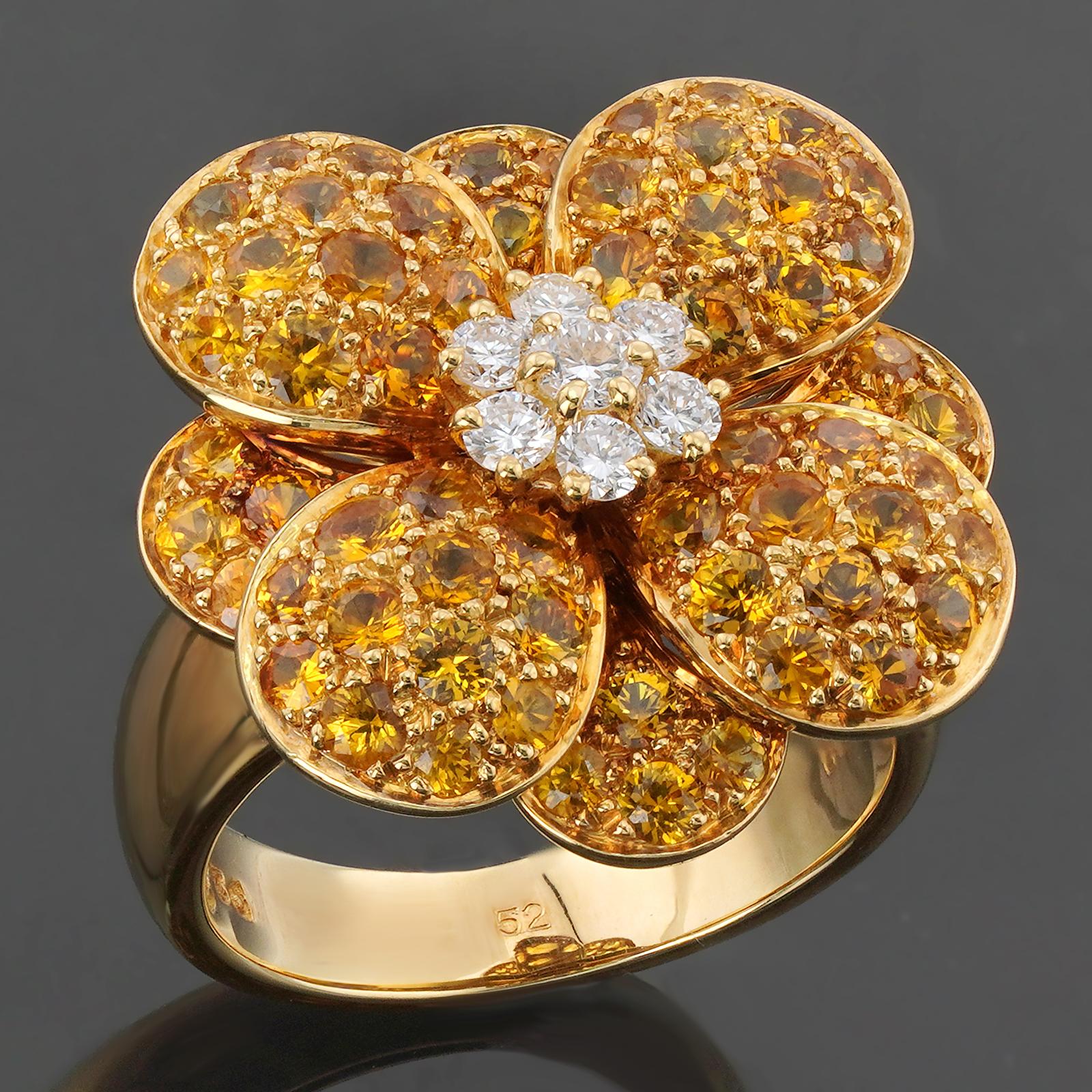 This stunning authentic Van Cleef & Arpels ring features a vibrant flower design crafted in 18k yellow gold and set with yellow sapphires and round brilliant E-F-G VVS1-VVS2 diamonds. Made in France circa 1990s. Measurements: 0.78