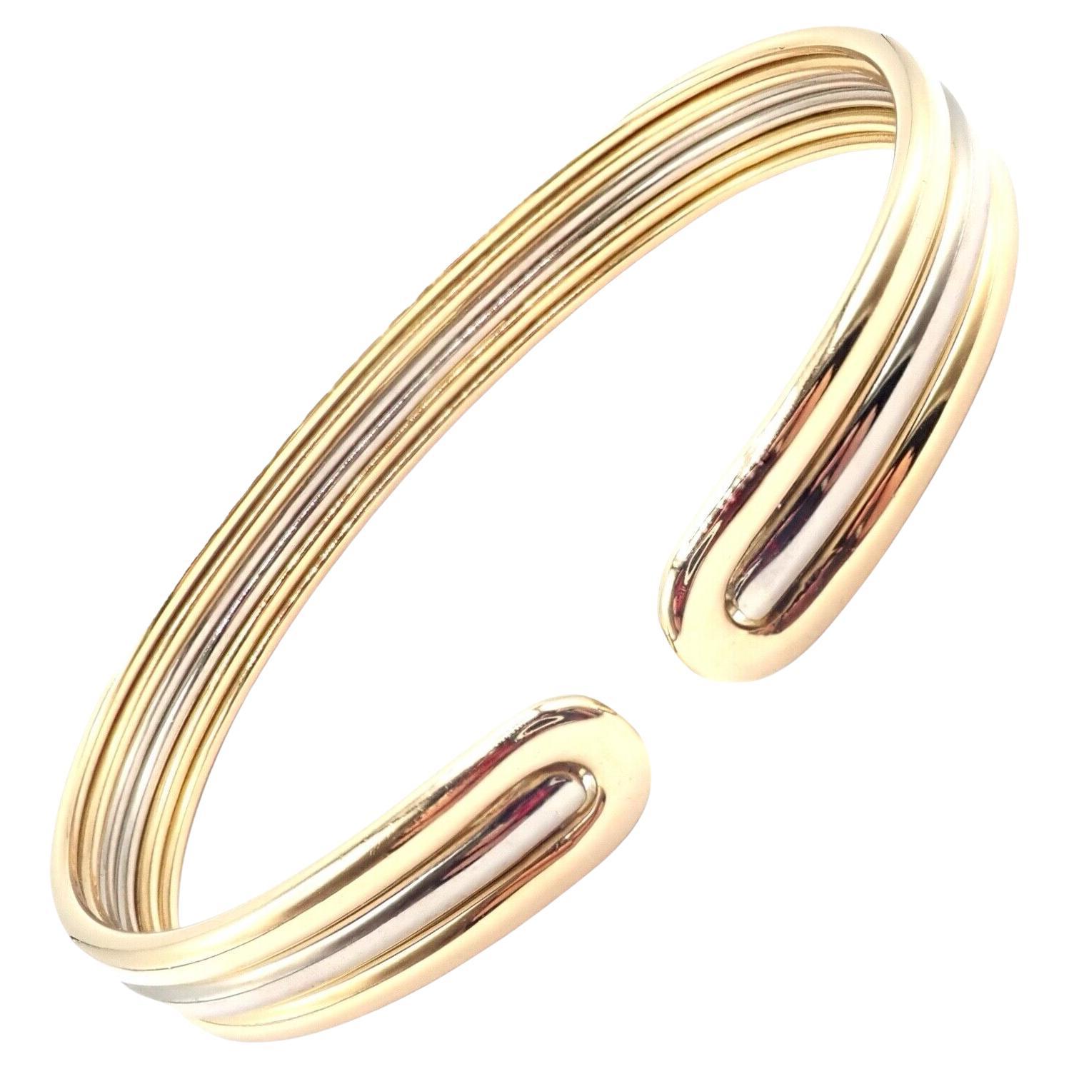 18k White & Yellow Gold Cuff Bangle Bracelet by Van Cleef & Arpels. 
The Van Cleef & Arpels bangle cuff bracelet is an epitome of sophistication, crafted from 18k yellow and white gold. 
This elegant piece showcases a timeless design, blending two