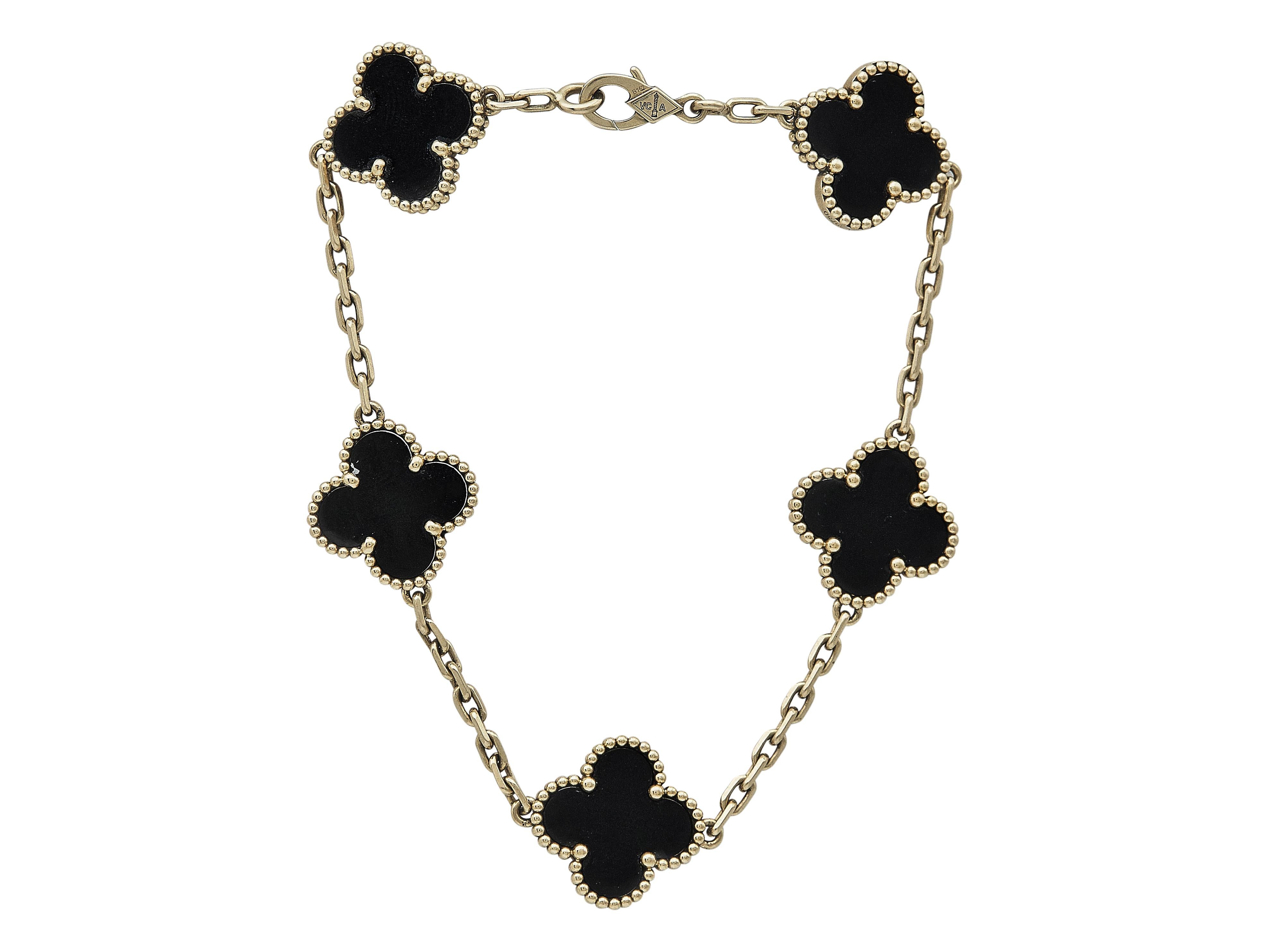 The bracelet: A Van Cleef & Arpels Vintage Alhambra eighteen karat yellow gold bracelet with five onyx motifs. The highly polished onyx is carved into Van Cleef & Arpel's iconic clover motif. The five tablets are  set in beaded gold, and strung
