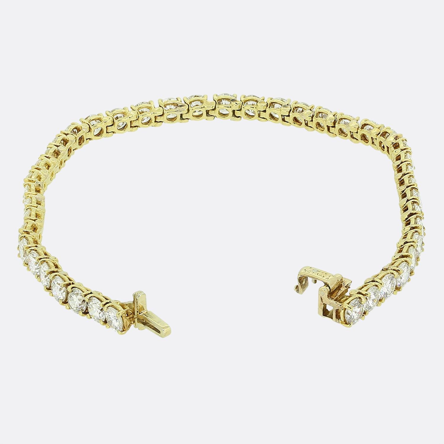 Here we have an 18ct yellow gold tennis bracelet from the world renowned luxury jewellery house of Van Cleef & Arpels. This exquisite piece showcases a continuous line of round brilliant-cut white diamonds, each meticulously claw set to enhance