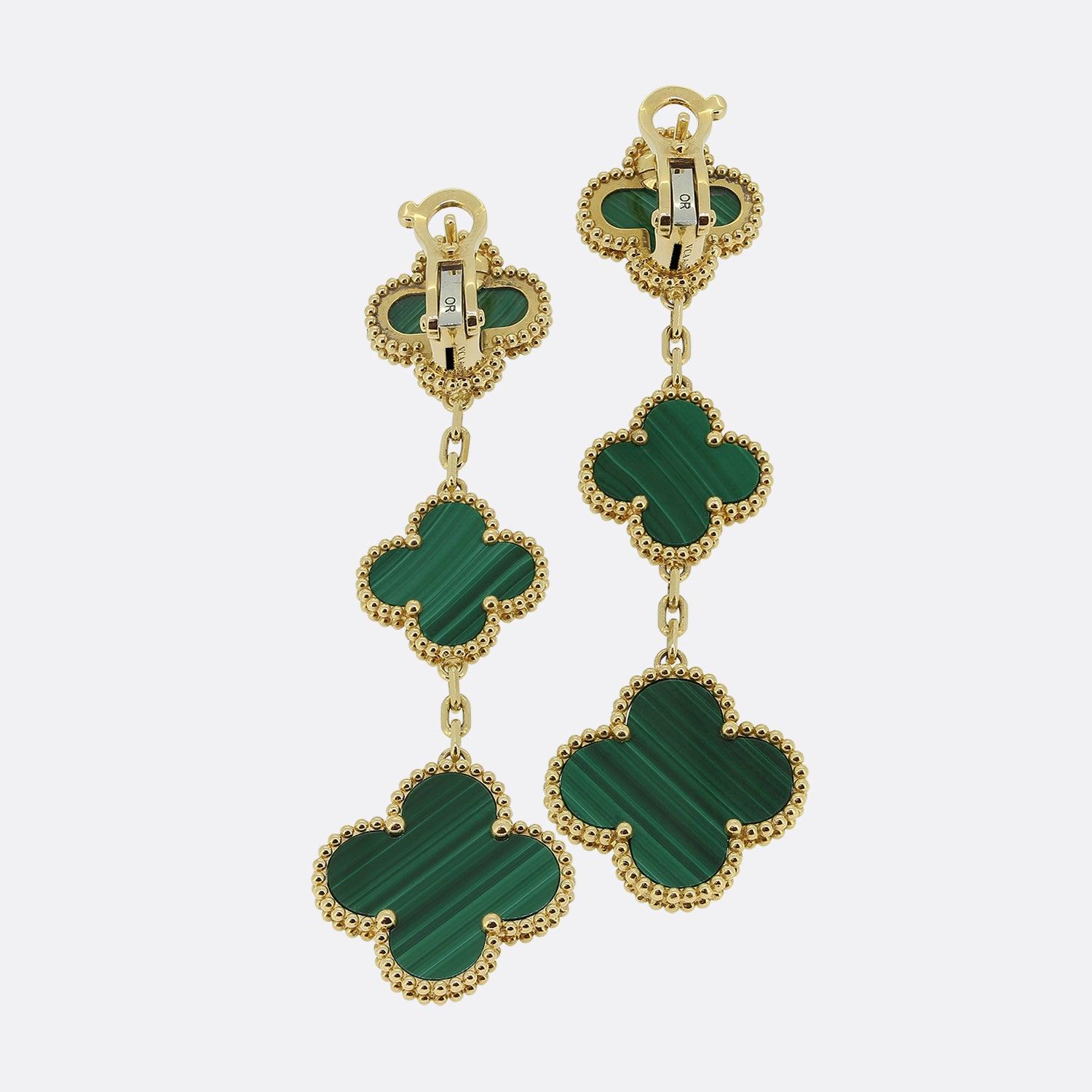 Here we have a luxurious pair of 18ct yellow gold malachite earrings by Van Cleef & Arpels from their Magic Alhambra collection. Each piece showcases 3 four leaf clover motifs set to the centre with malachite and complemented with a beaded outer