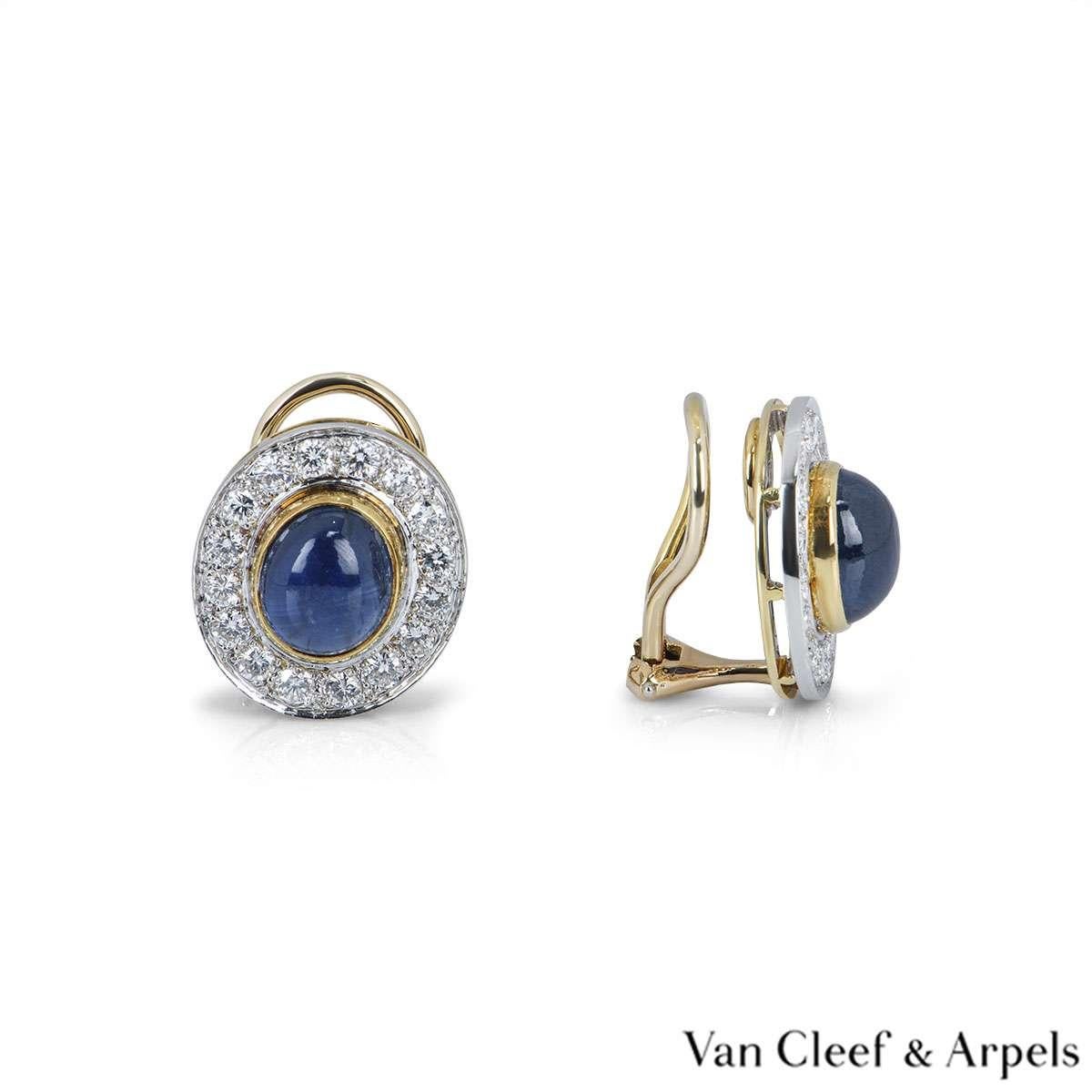 A beautiful pair of 18k yellow gold clip-on earrings by Van Cleef & Arpels. The earrings are set with a large cabochon cut blue sapphire in the centre and 16 round brilliant cut diamonds around the outer edge. The earrings feature a hinged clip at