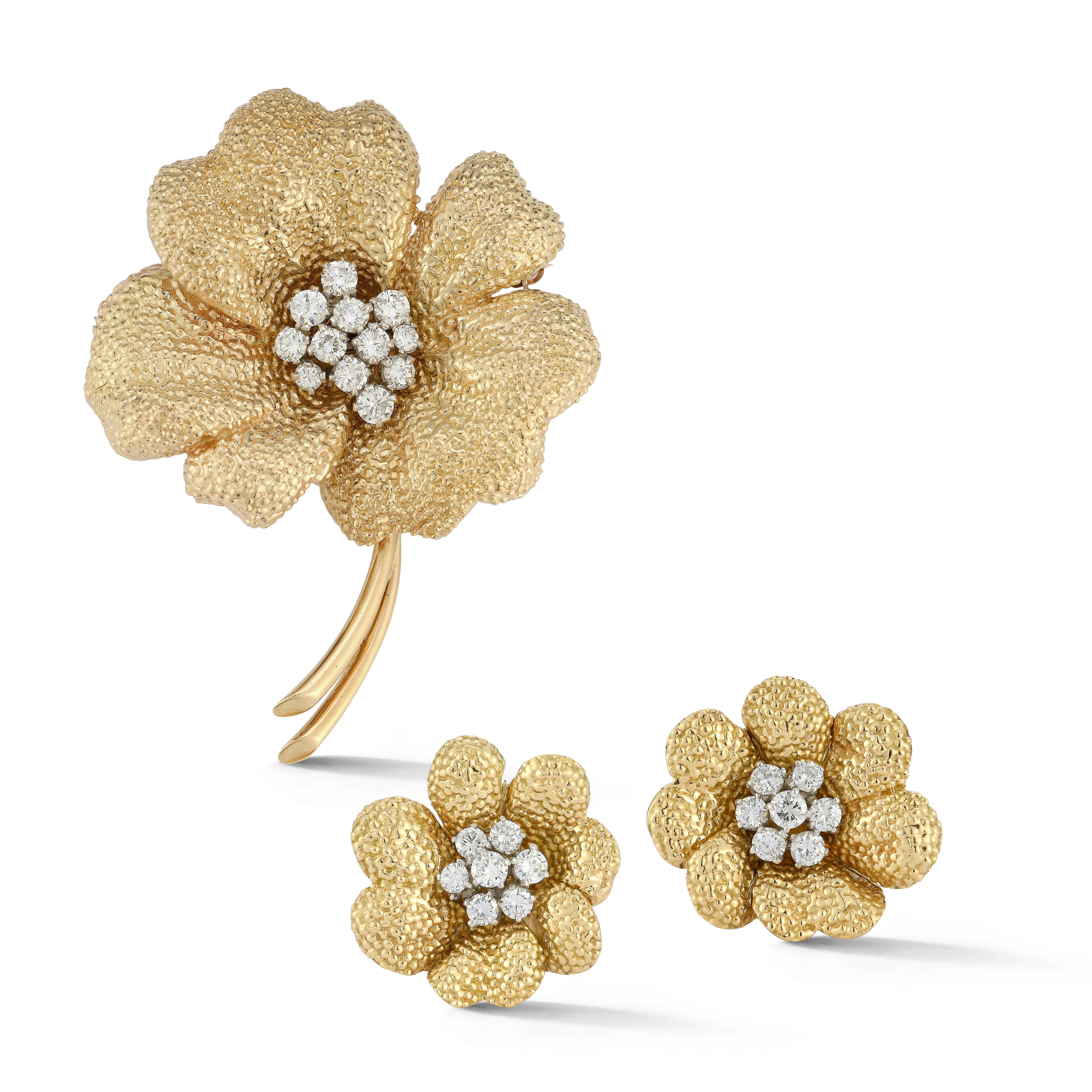 Van Cleef Diamond Flower Brooch & Earrings
 
Set with 12 diamonds clustered together as the center of the flower. Along with a pair of matching earrings set with 7 diamonds in the center of the flower set in 18 karat textured yellow gold.

Brooch