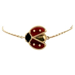 Van Cleef Lucky Spring, or rose 18 carats, onyx, cornaline, boîte et papiers