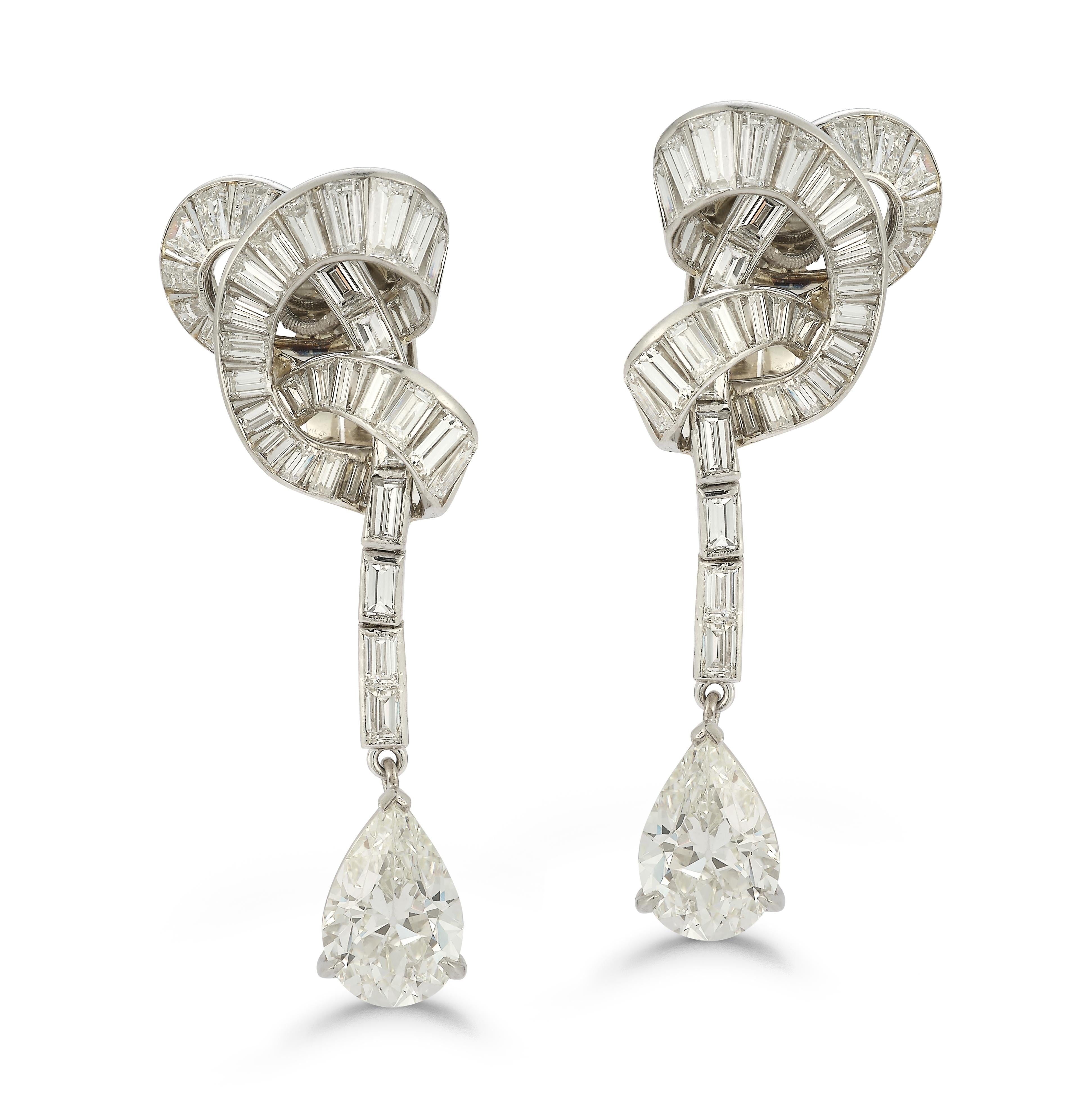 Van Cleef Pear Shape Diamond Earrings

Pear shape diamonds hanging from a knot of baguette diamonds set in platinum and white gold

Pear Diamond weight: 2.63ct J VS1 and 2.88ct K VS1
Baguette Diamonds weight: approximately 7.75ct
Total Diamond