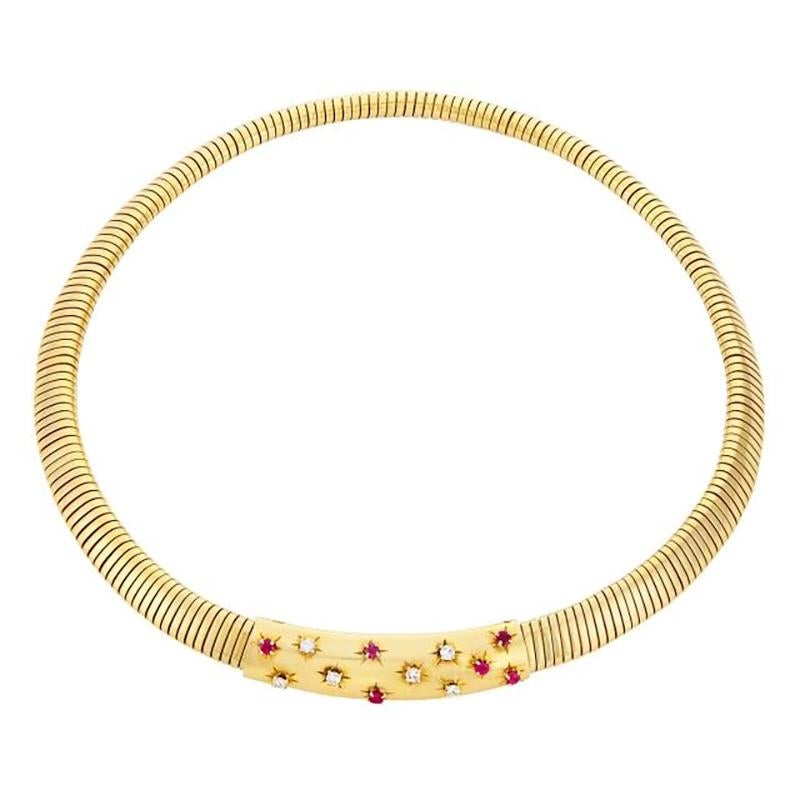 Gold, Ruby and Diamond Snake Link Necklace, Van Cleef & Arpels. Made in France, circa 1950.
18 kt., centering a curved polished panel accented by 6 round diamonds approximately .40 ct., and 6 round rubies, completed by a snake link necklace, signed