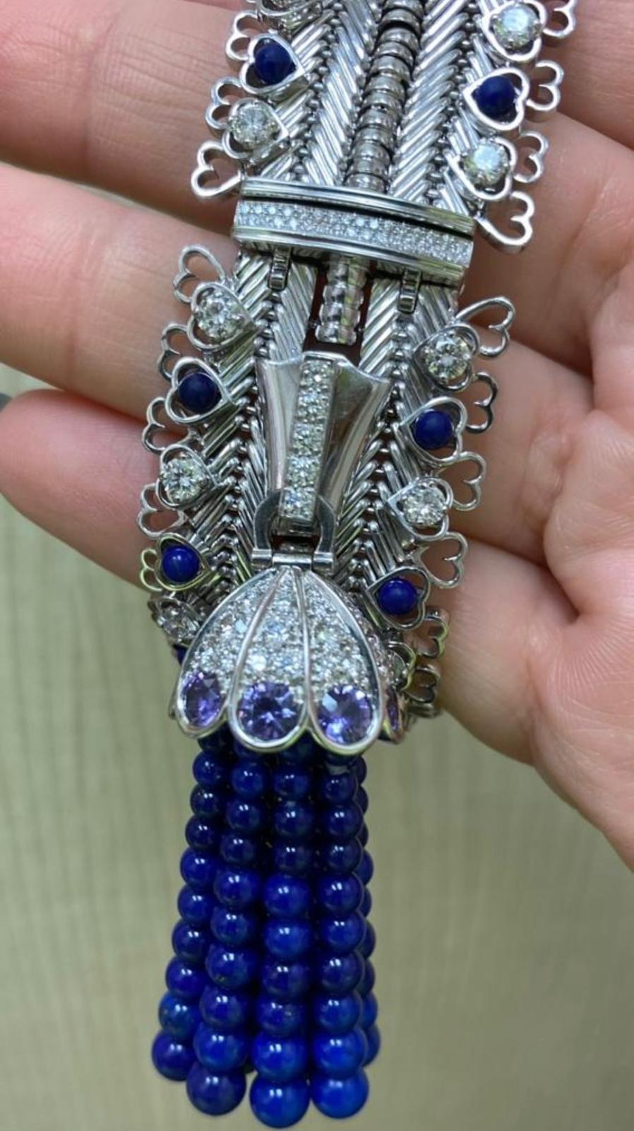 Originally created in 1950 for the Dutchess of Windsor, the Zip necklace has since been an icon of the maison.

Zip Antique Coupoles Necklace, one of a kind, 18k white gold, round diamonds, mauve sapphires, lapis lazuli beads and cabochon. Fully