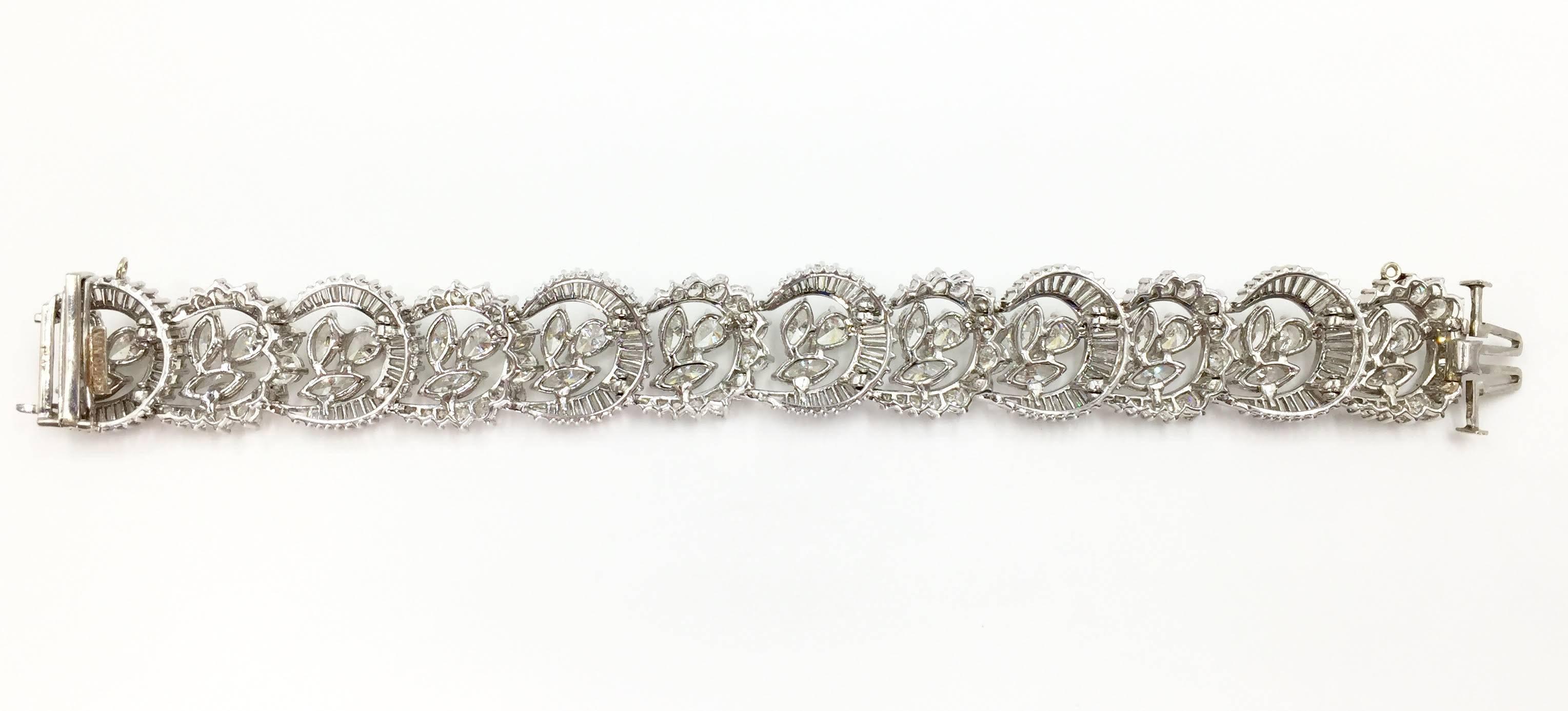 Perfect for the high-fashion antique jewelry lover. This beautifully designed, signed Van Clief, platinum bracelet with crescent shaped links of alternating rows of round brilliant and baguette diamonds give this bracelet a unique design with lots