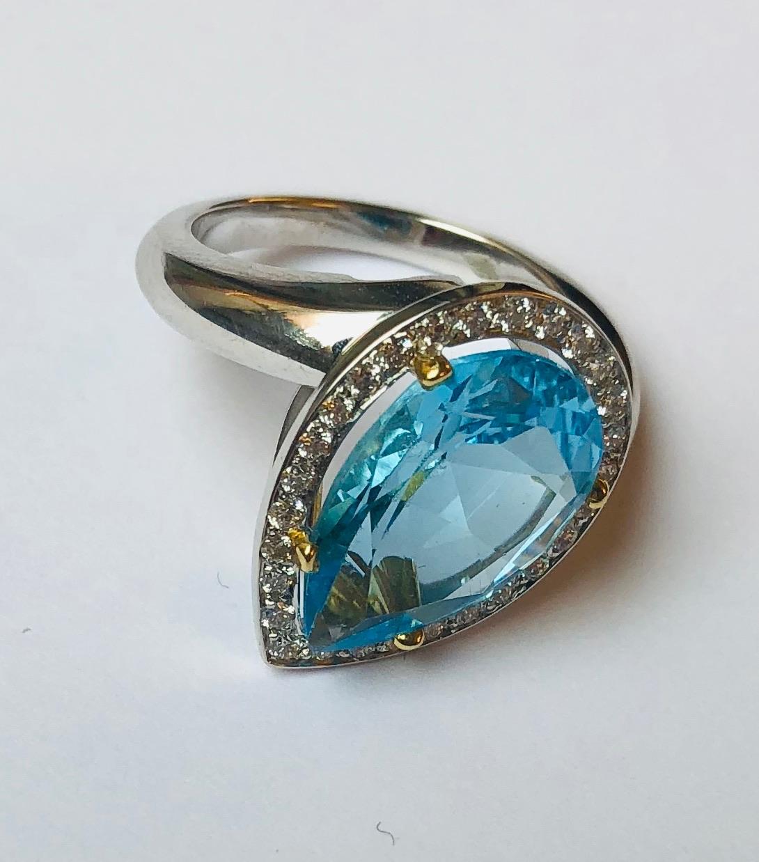 This beautifully crafted ring features a large Blue Topaz set in white gold 18 kt. and is surrounded by diamonds. 
This ring was designed and made by Van der Veken, an Antwerp, Belgium-based High Jewelry house founded in 1952. Each jewel is unique,