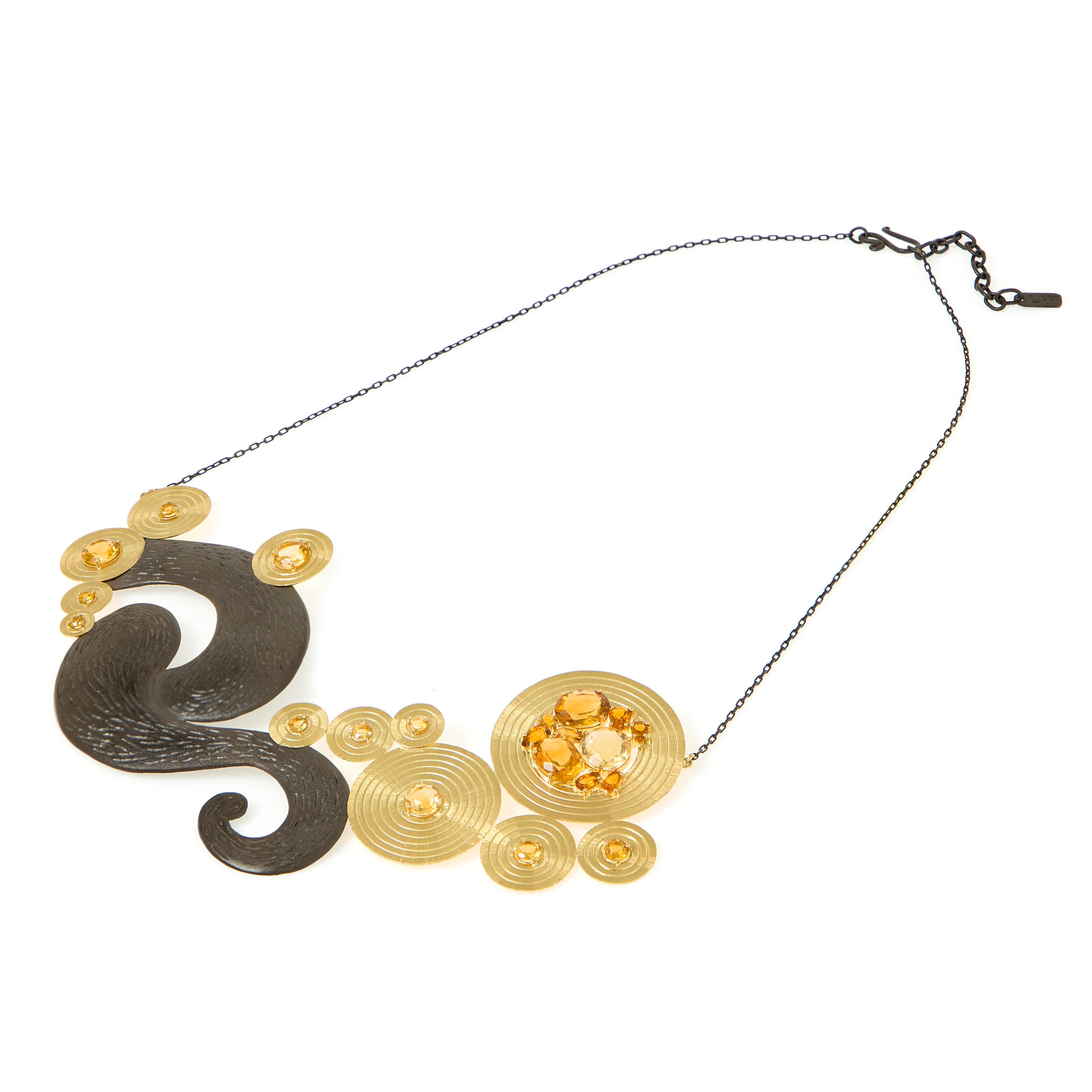Necklace
Gold 18K, Silver 95O
Light Citrine and Dark Citrine
Handmade, bright polished, matte finish and prong setting

This necklace is inspired by Van Gogh’s “Starry Night”.  Carved gold circles with citrines represent the light emanating from the