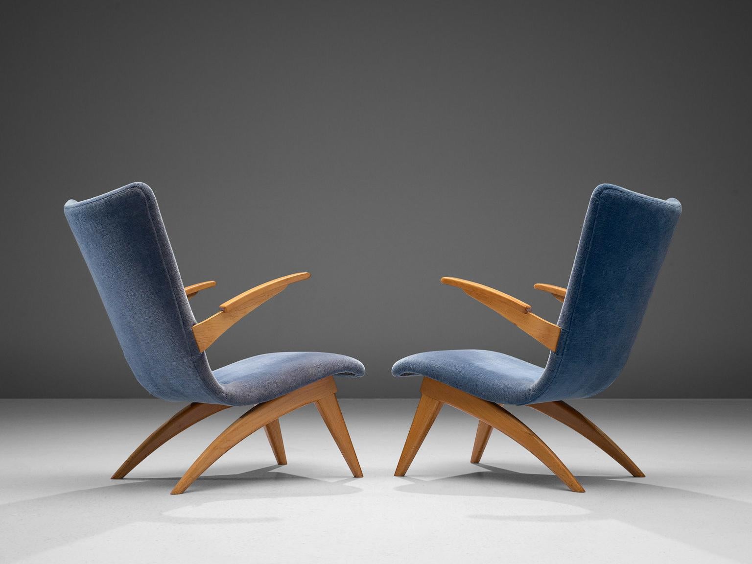 G. Van Os for Van Os Culemborg, pair of armchairs, beech and fabric, The Netherlands, 1950s.

This pair of easy chairs is designed by Dutch designer G. Van Os in the 1950s. These lounge chairs, executed in beech and blue fabric have backrests that