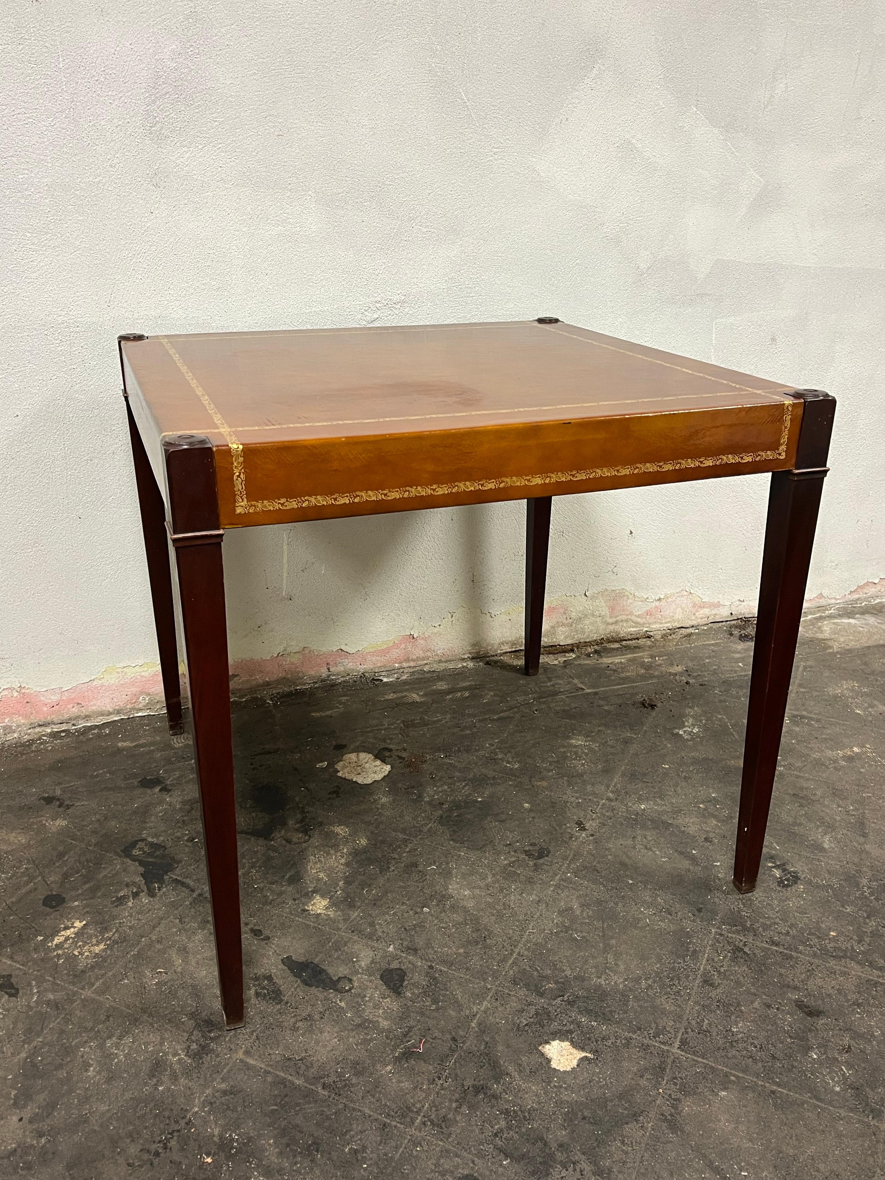 Beautiful leather top game table with gold embossed trim. Nicely tapered leg  giving a modern tradition style. 
Curbside to NYC/Philly $450