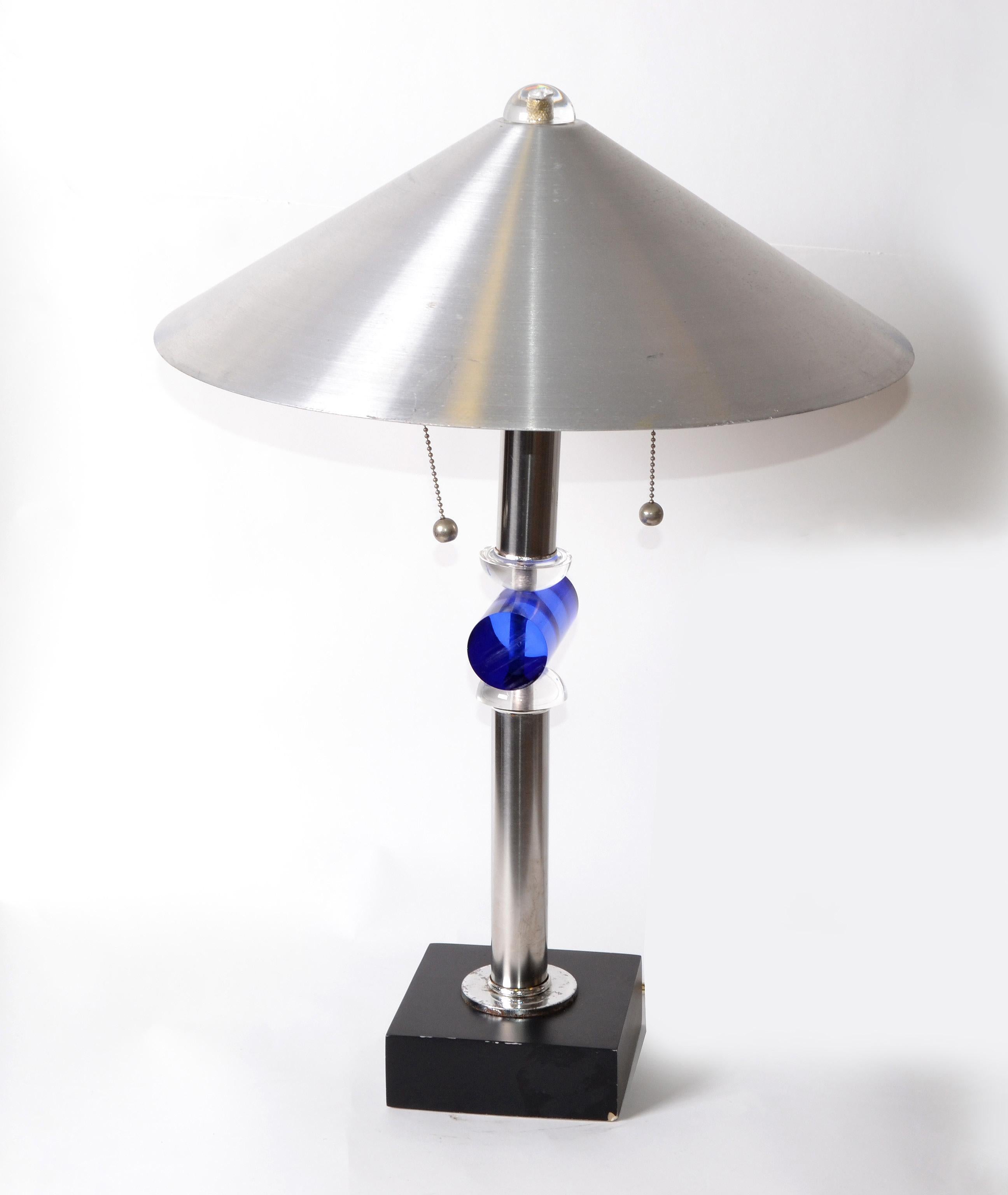 Van Teal circa 1970s, this clear and blue Lucite, geometric-style table lamp on a black wooden base, 
Double Sockets with pull strings, US wired and uses 2 max. 75 watts light bulbs.

Brushed aluminum shade: 18.5 inches diameter x 6.5 inches