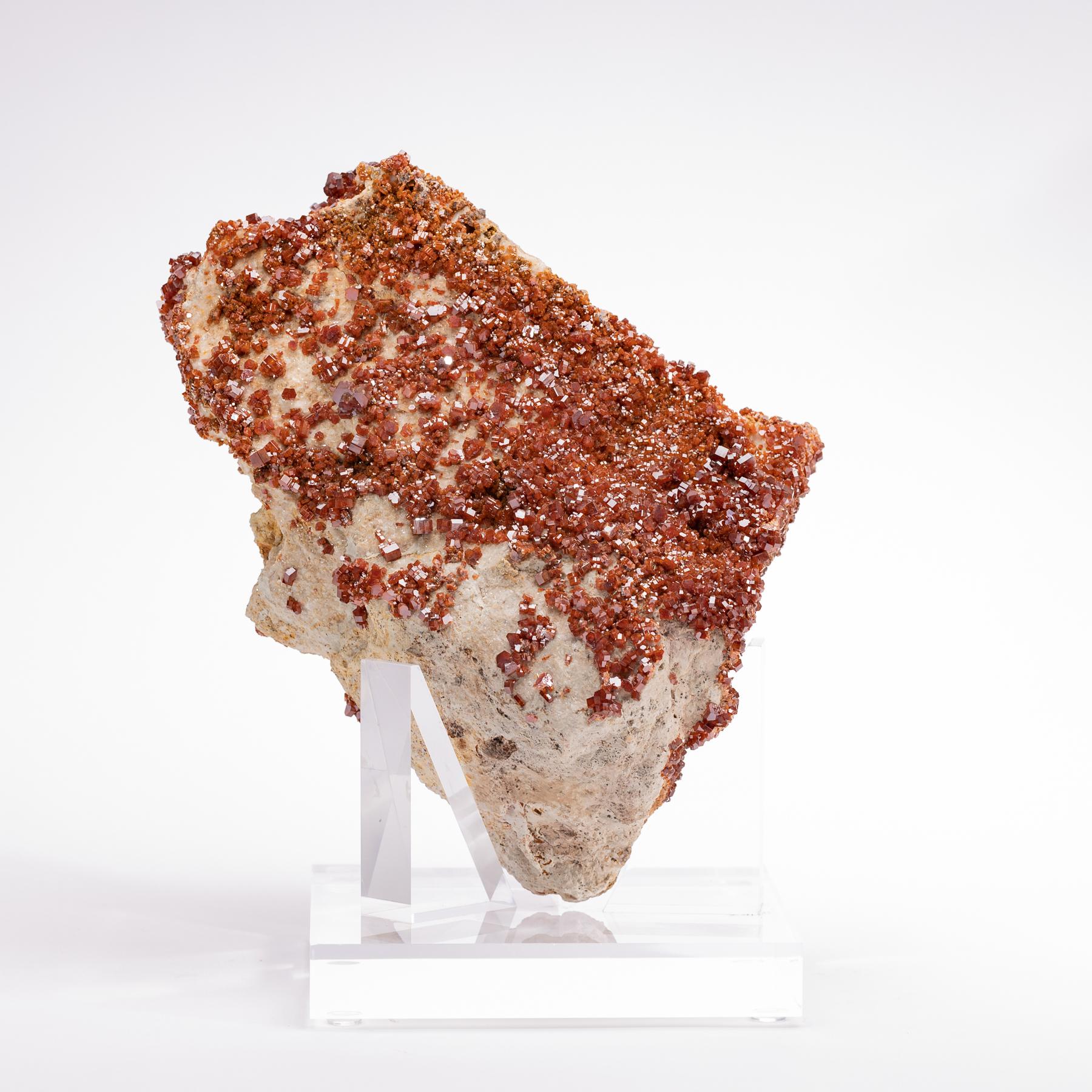 Top quality vanadinite crystals with vibrant red / orange colors and lots of blink mounted on custom acrylic base.