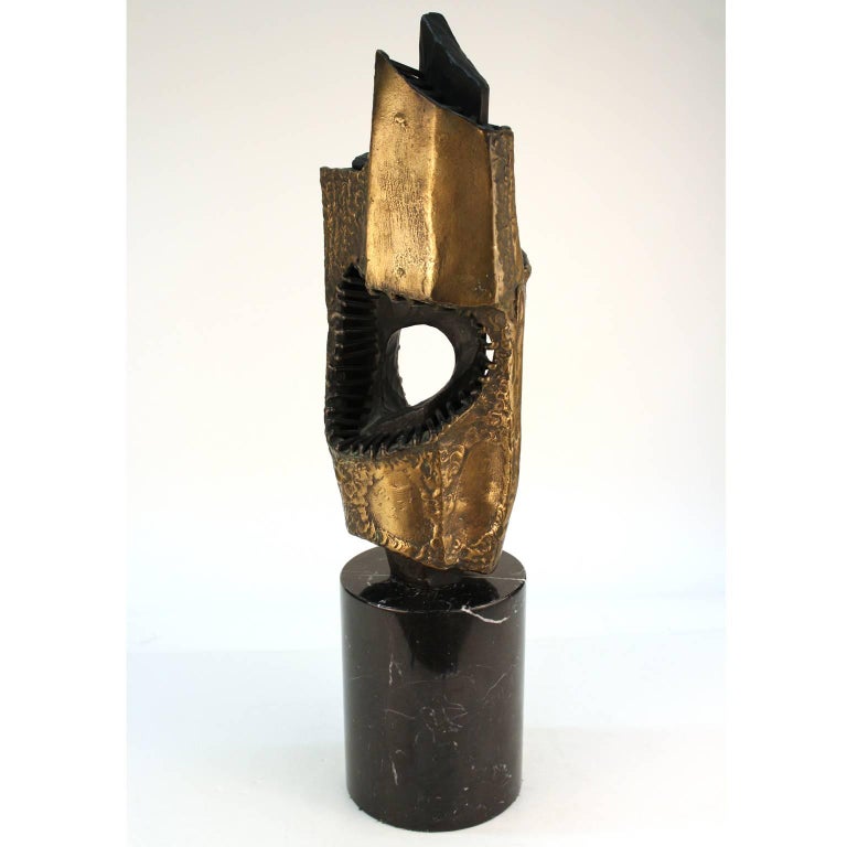 A Brutalist abstract sculpture in welded bronze with partial gold patina, made by Vandevoorde in the 1960s-1970s. Signed. Good overall condition. Original wooden base has plaque with title 'La Vie Interieure De L'Homme'. A cylindrical 8 inch marble