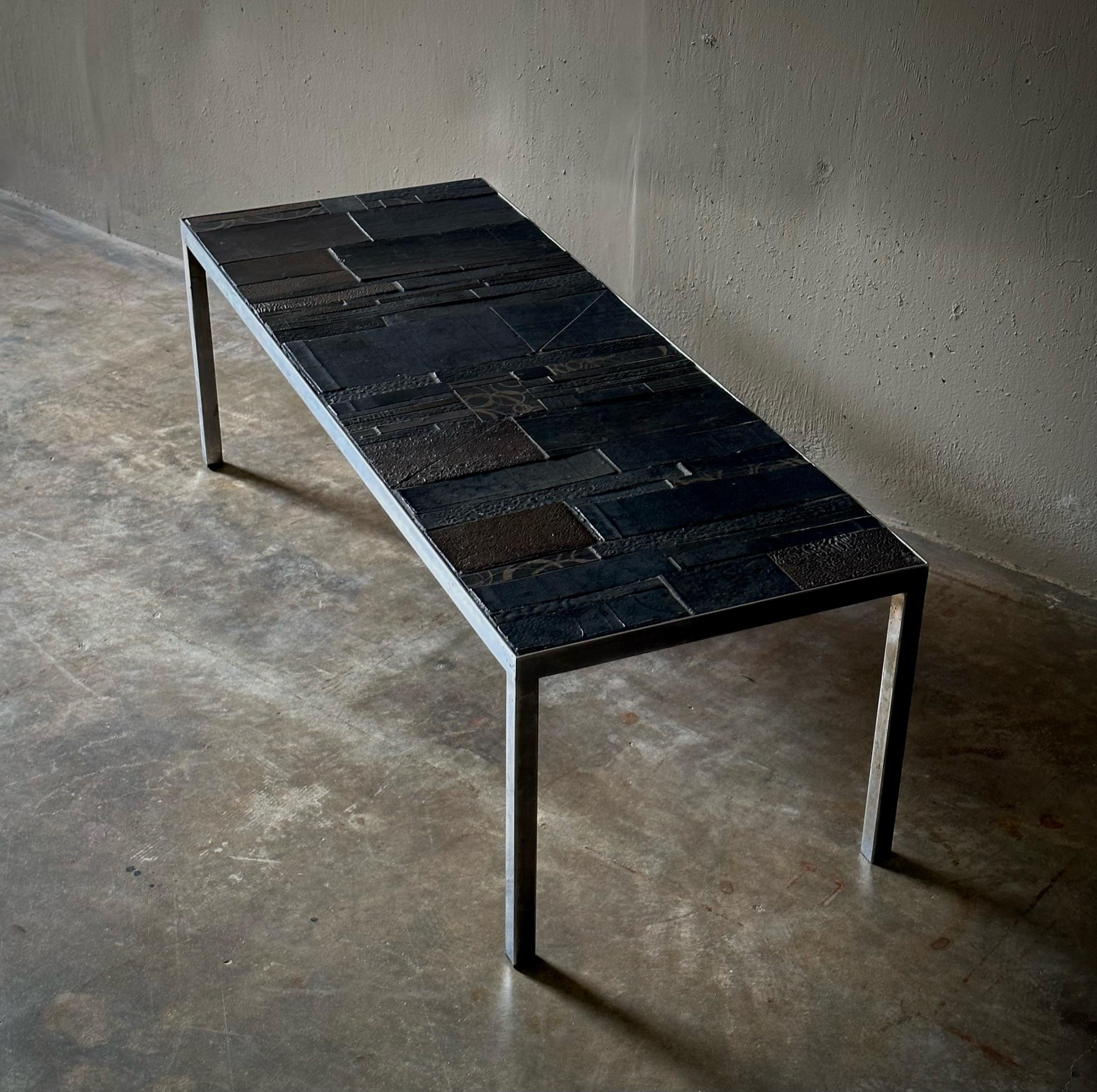 Low rectangular coffee table with ceramic tile top designed by Belgian designer Rogier Vandeweghe and produced by Amphora in 1960s Brugges. The tabletop has a wonderfully earthy, mineral feel with an abstract graphic design.

Belgium, circa