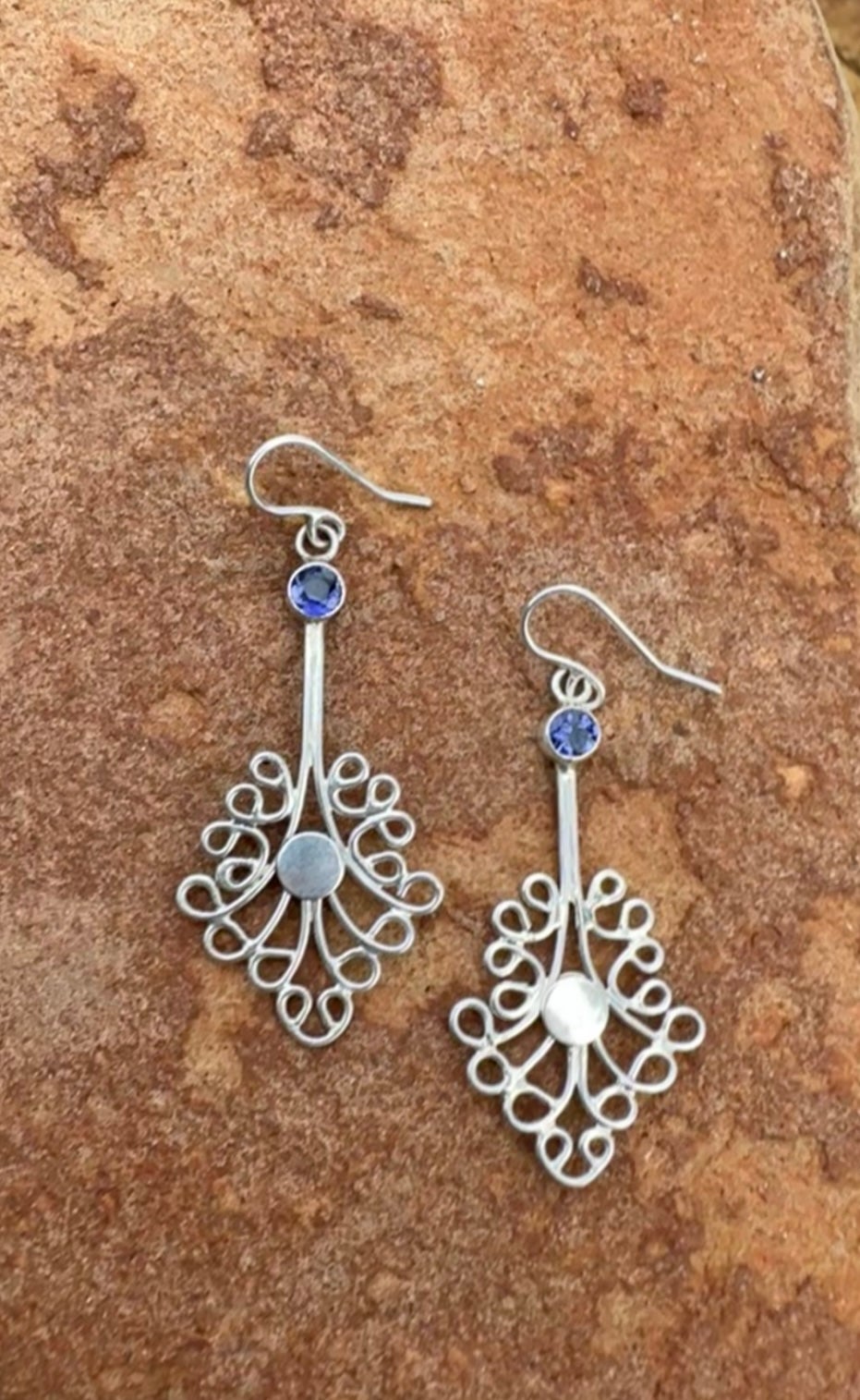 - Available
-Handmade
- Sterling silver
- lolite stone
- Length 60mm

Inspired by the intricate motifs found in traditional Indonesian jewelry, these earrings boast delicate open filigree work that exudes elegance and sophistication. Crafted with