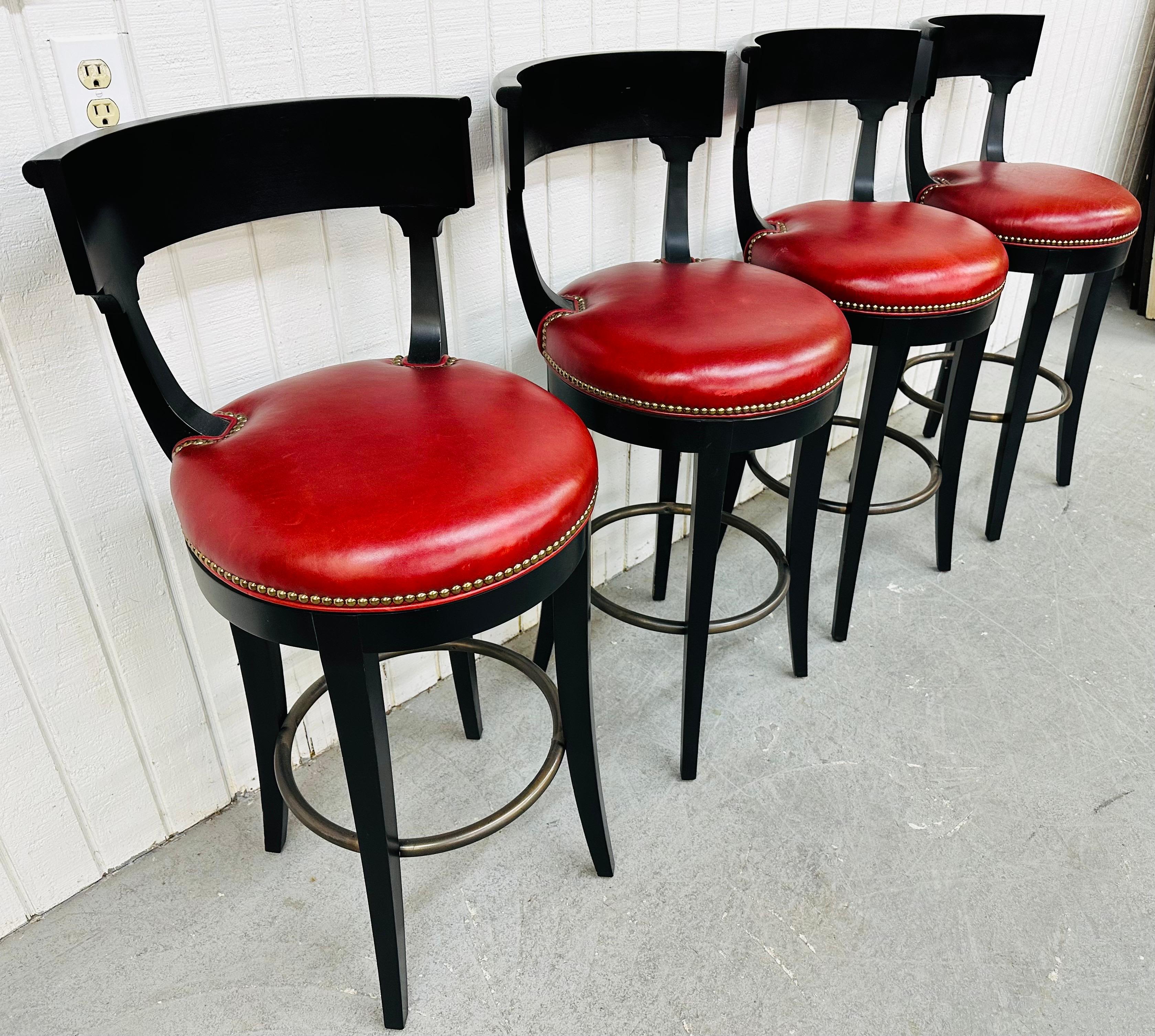This listing is for a set of four Vanguard Modern Ebonized Bar Stools. Featuring a wooden ebonized frame, red vinyl upholstery, nailhead accent, and chrome foot rest. This is an exceptional combination of quality and design by Vanguard!