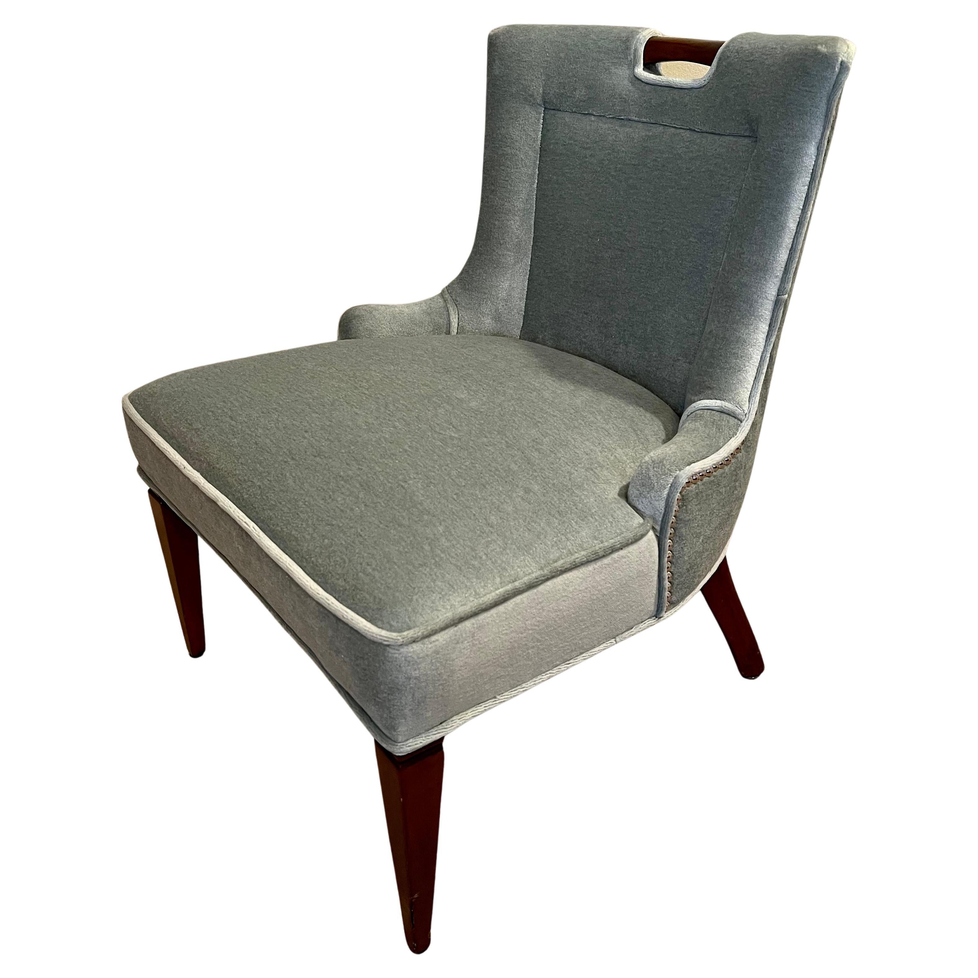 A lovely vanity chair with wood frame that is exposed in the top rear s a handle of sorts... the upholstery is new in a mint gray mohair - very chic and rich looking... a compliment to any vanity or small desk. 

The fabric is rich and a nail head