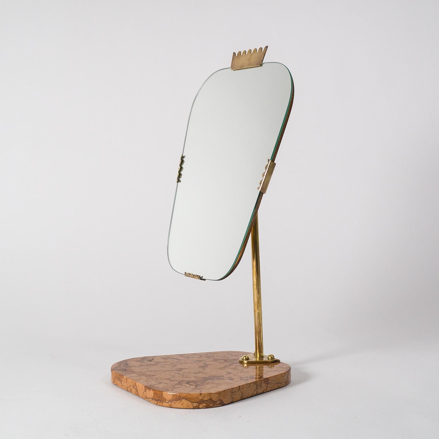 Beautiful Swedish vanity mirror, late Art Deco, circa 1940. Solid red stone base with a brass arm and pivoting mechanism holds a tapered mirror with teak backplate and brass details. Very nice condition with patina on the brass. Mirror measures: