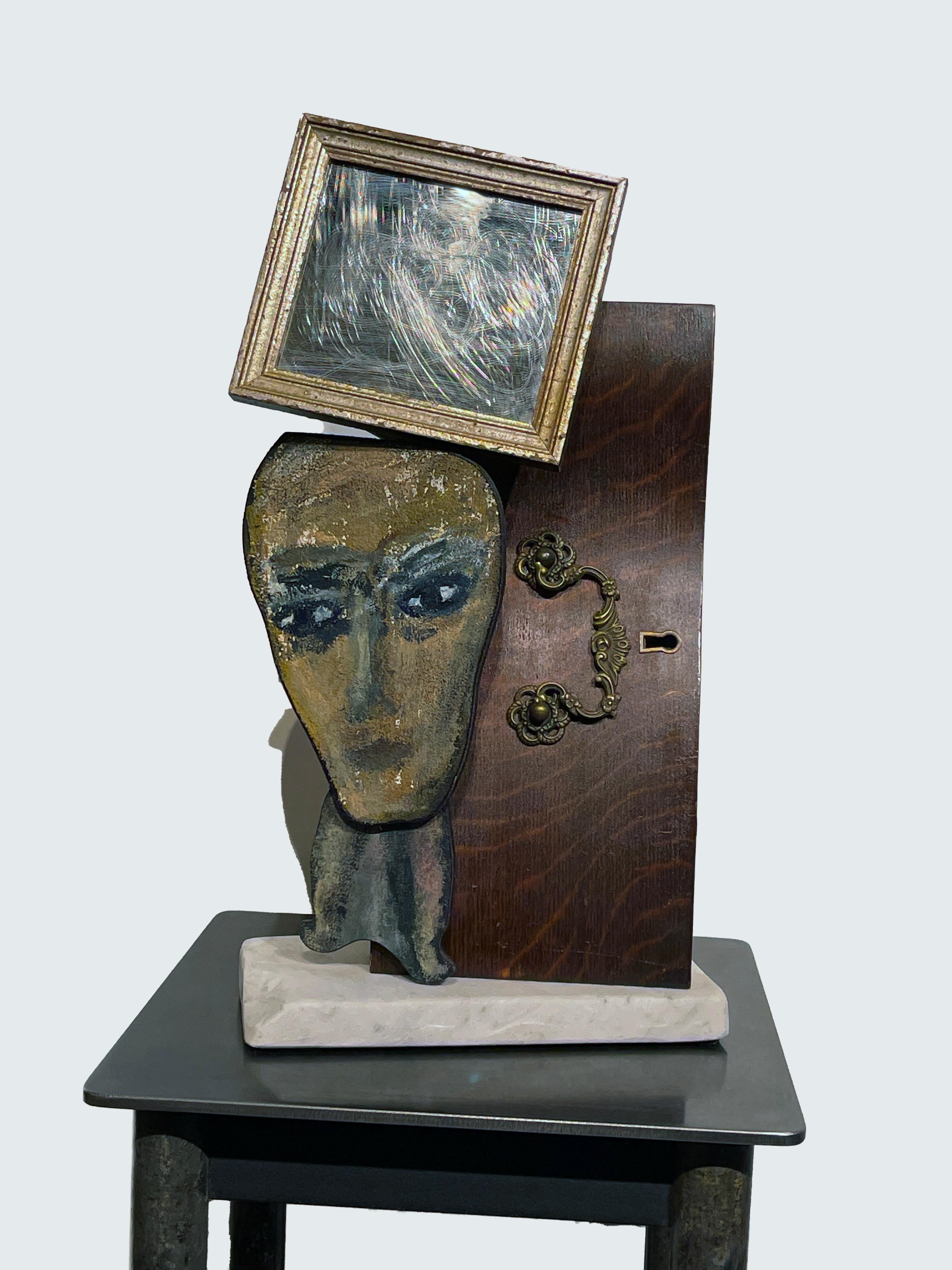 Self-taught artist John Seubert, AKA John Dolly, uses objects he uncovers as he rehabs older homes in Chicago. This piece is constructed with a small framed mirror and a drawer front complete with hardware which form the backdrop to a small portrait