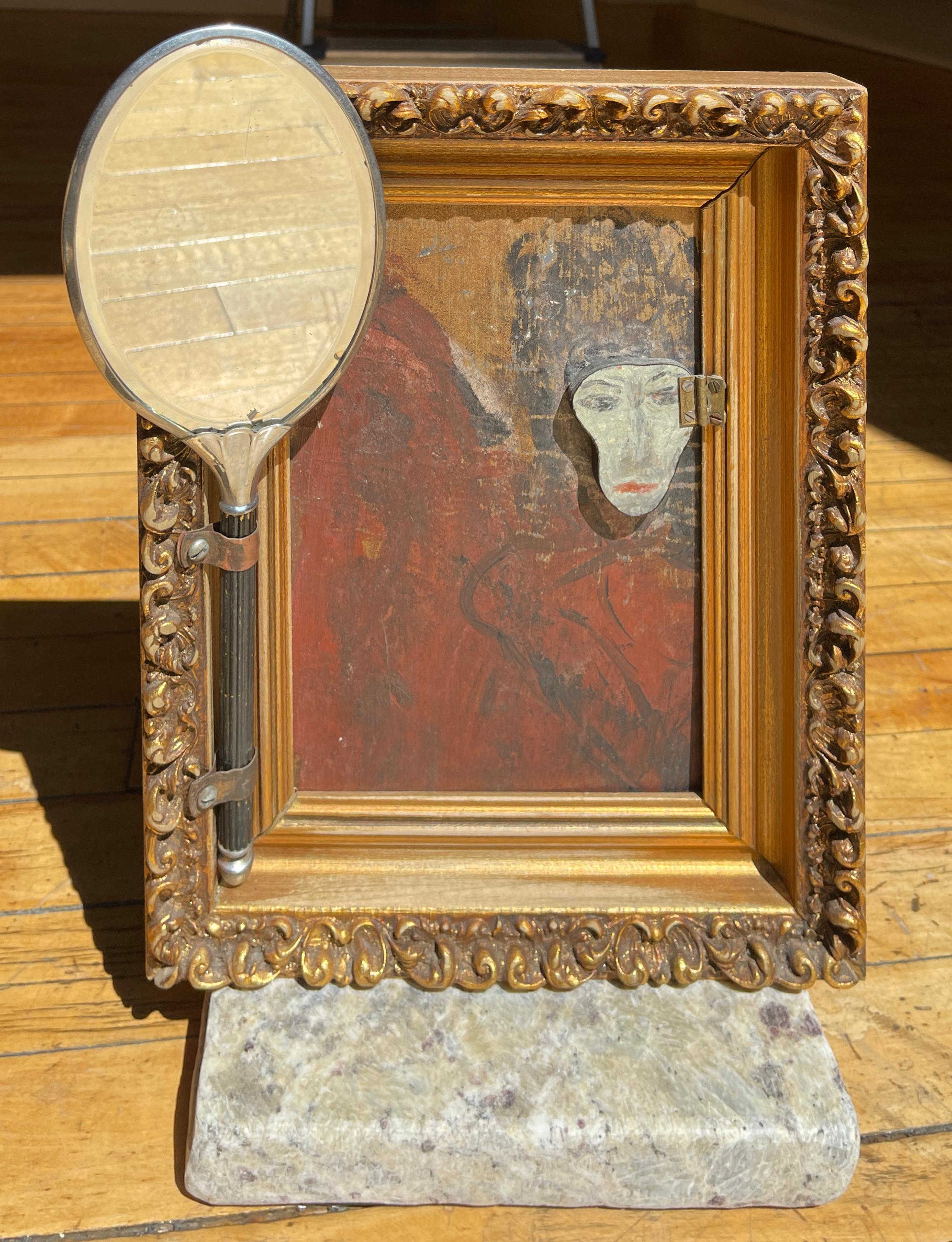 Self-taught artist John Seubert, AKA John Dolly, uses objects he uncovers as he rehabs older homes in Chicago. This piece has two handmade frames mounted back to back. Each side is a different treasure to discover. The front is a smoked mirror and