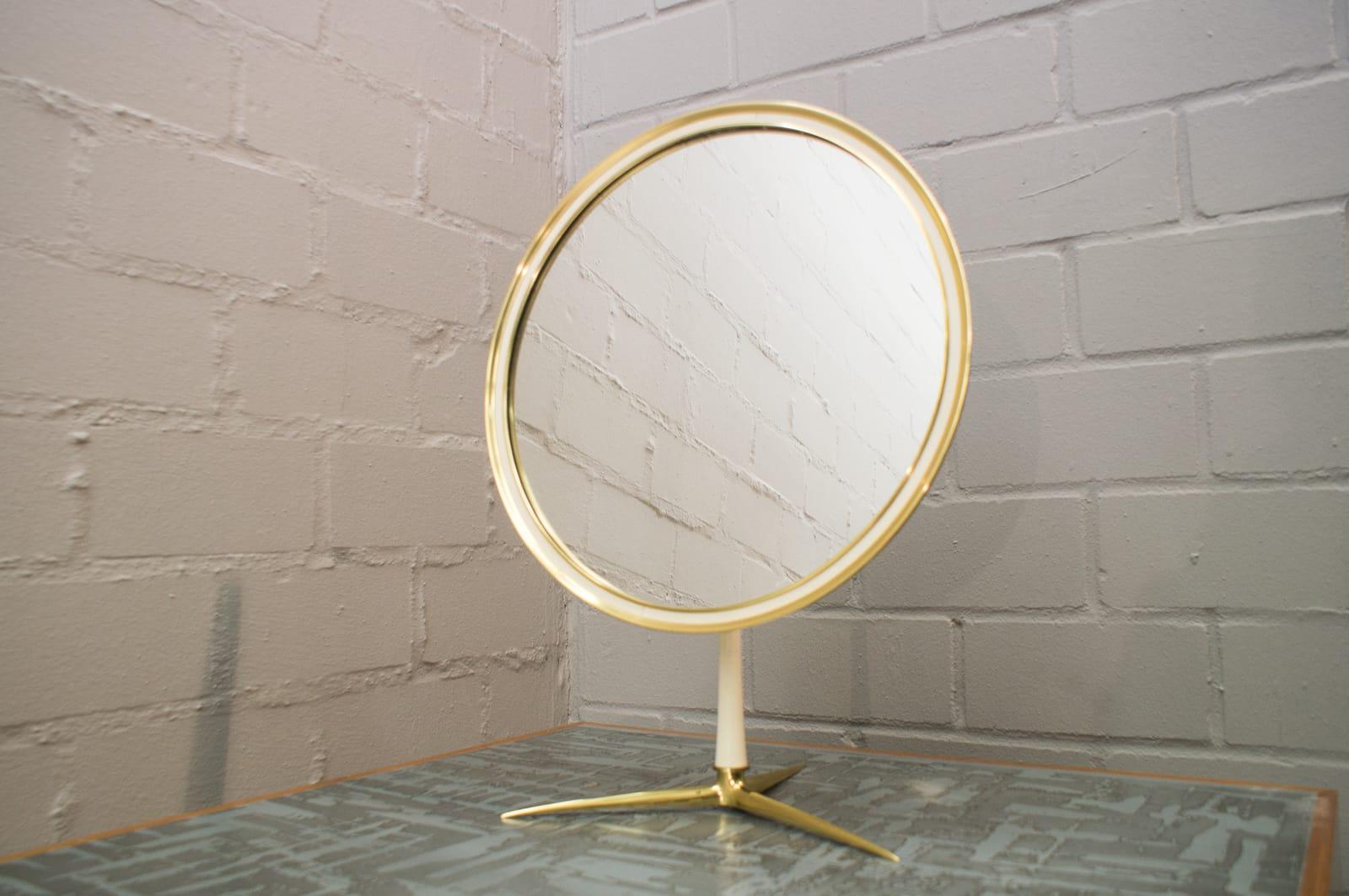 Exceptional Mid-Century Modern table mirror with brass frame.
This large make-up mirror is executed in solid brass and can be adjusted easily in wished position.
Manufactured by Vereinigte Werkstätten, Germany in 1960s.
Wear consistent with use