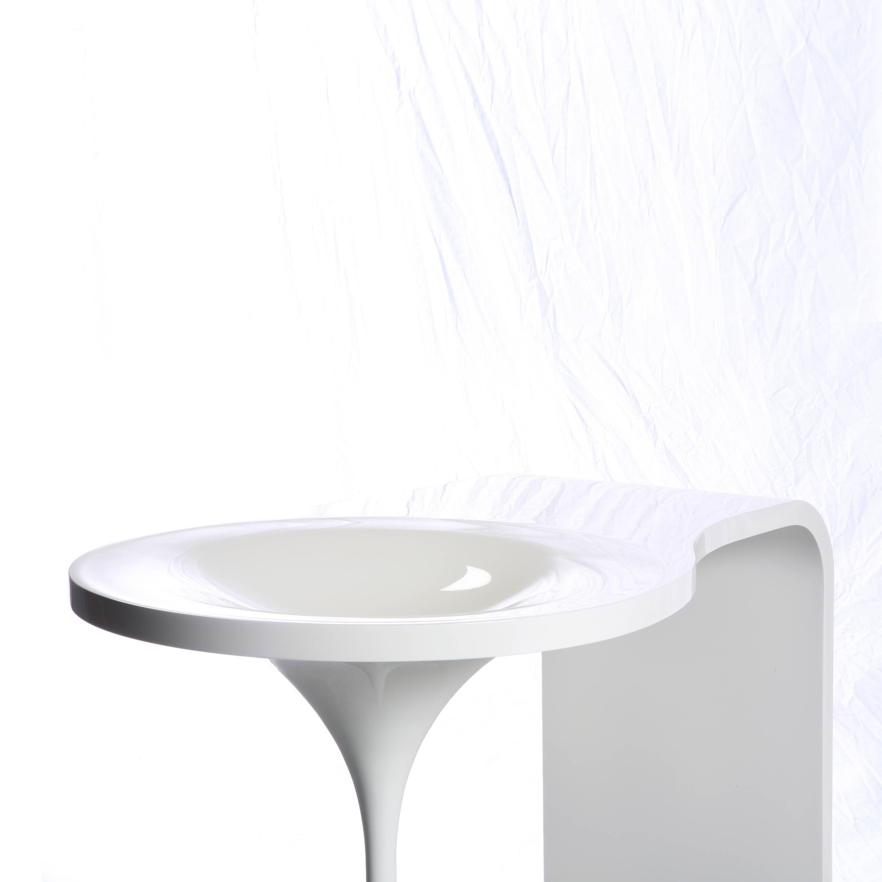 Inspired by melting snow and icicles, this small vanity table easily fits into the corner of most bedrooms. The shiny table surface incorporates a bowl for holding cosmetics. It can also function as an entry table holding water for flowers, keys, or