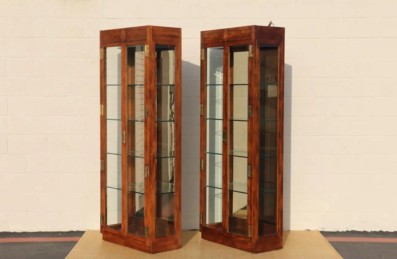 Wonderful pair of 1980’s Campaign Style Curio Display Cabinets by Henredon. They have the label in the back.
This beautiful pieces are made of wood, brass and glass.
Each of them have four adjustable glass shelves with plate grooves. Two of them