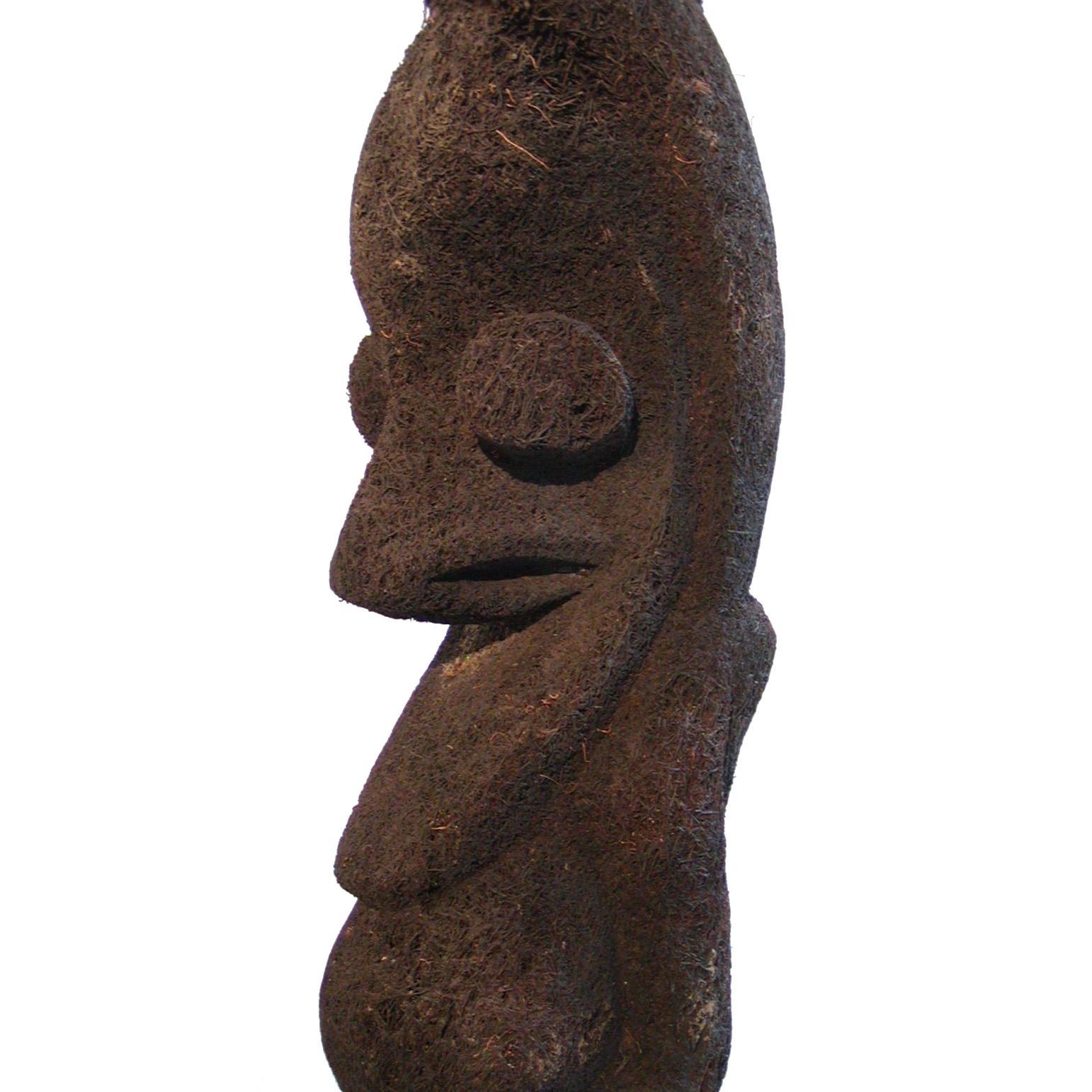 Vanuatu Fernwood Grade Ritual Figure, Ambrym Island. A sculpture carved from a solid section of the fibrous trunk of a tree fern composed of aerial roots surrounding a woody core, in the distinctive Vanuatu human form of a large headed male