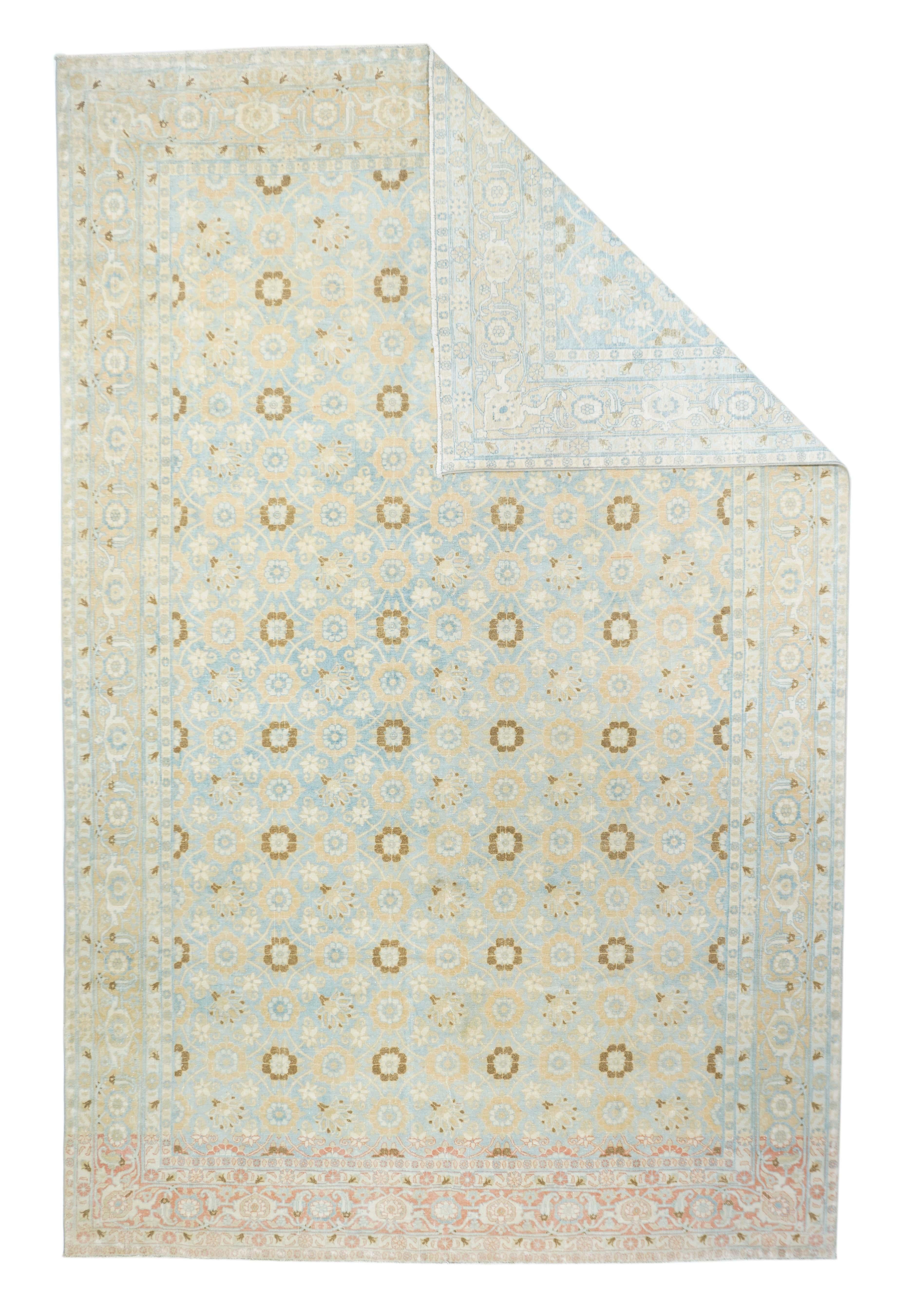 This is a more nearly pastel version of the characteristic light blue, Mina Khanitown Varamin carpets. The rosette trellis shows in four synchronised and two similar half side columns, uniformly accented in rust. Abrashed rust to straw main with