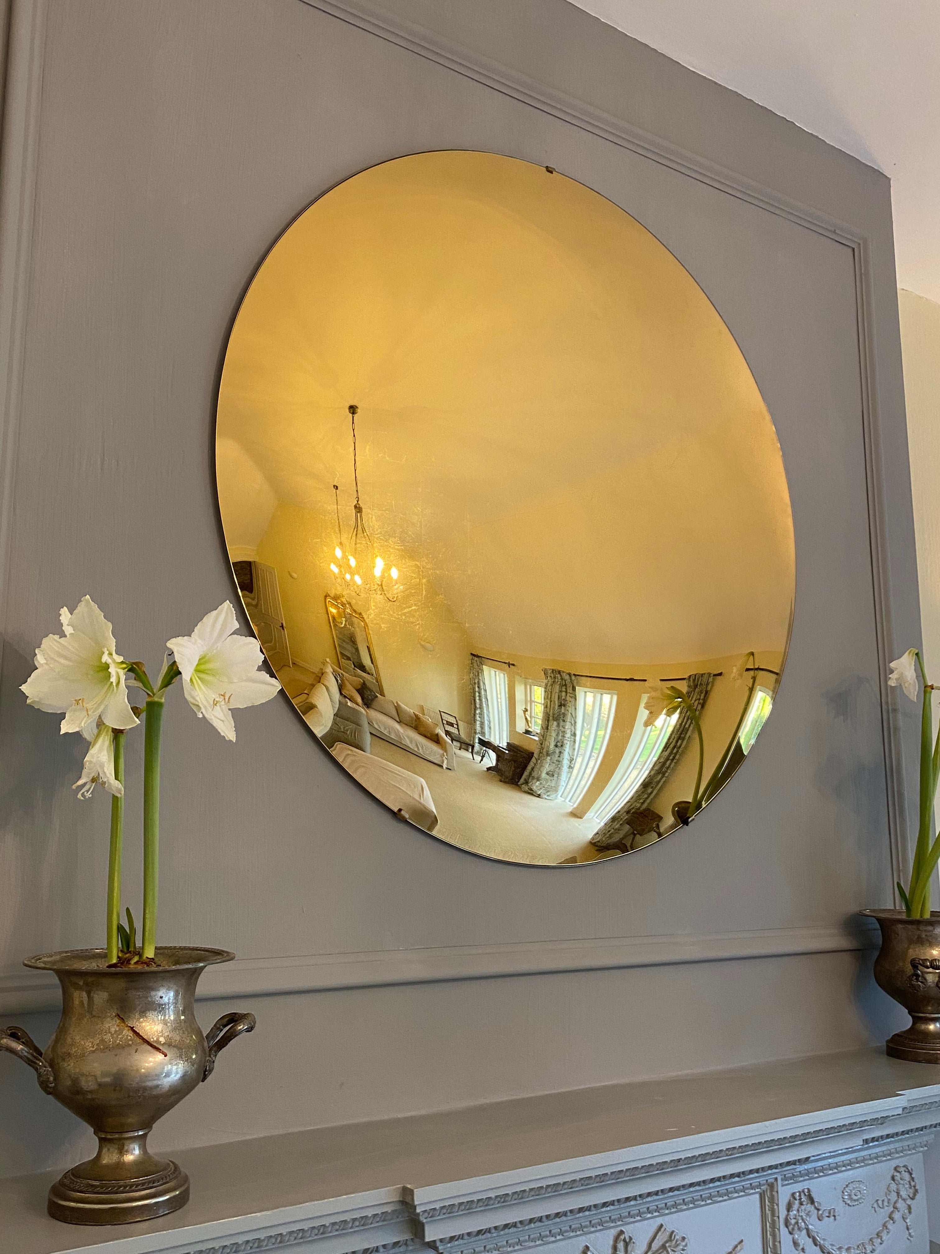 The Varenna glass convex wall mirror is fabricated from 6mm low iron glass for extra clarity. Verre églomisé is from the French term meaning glass gilded, is a process in which the back side of glass is gilded with gold or metal leaf. In one of a