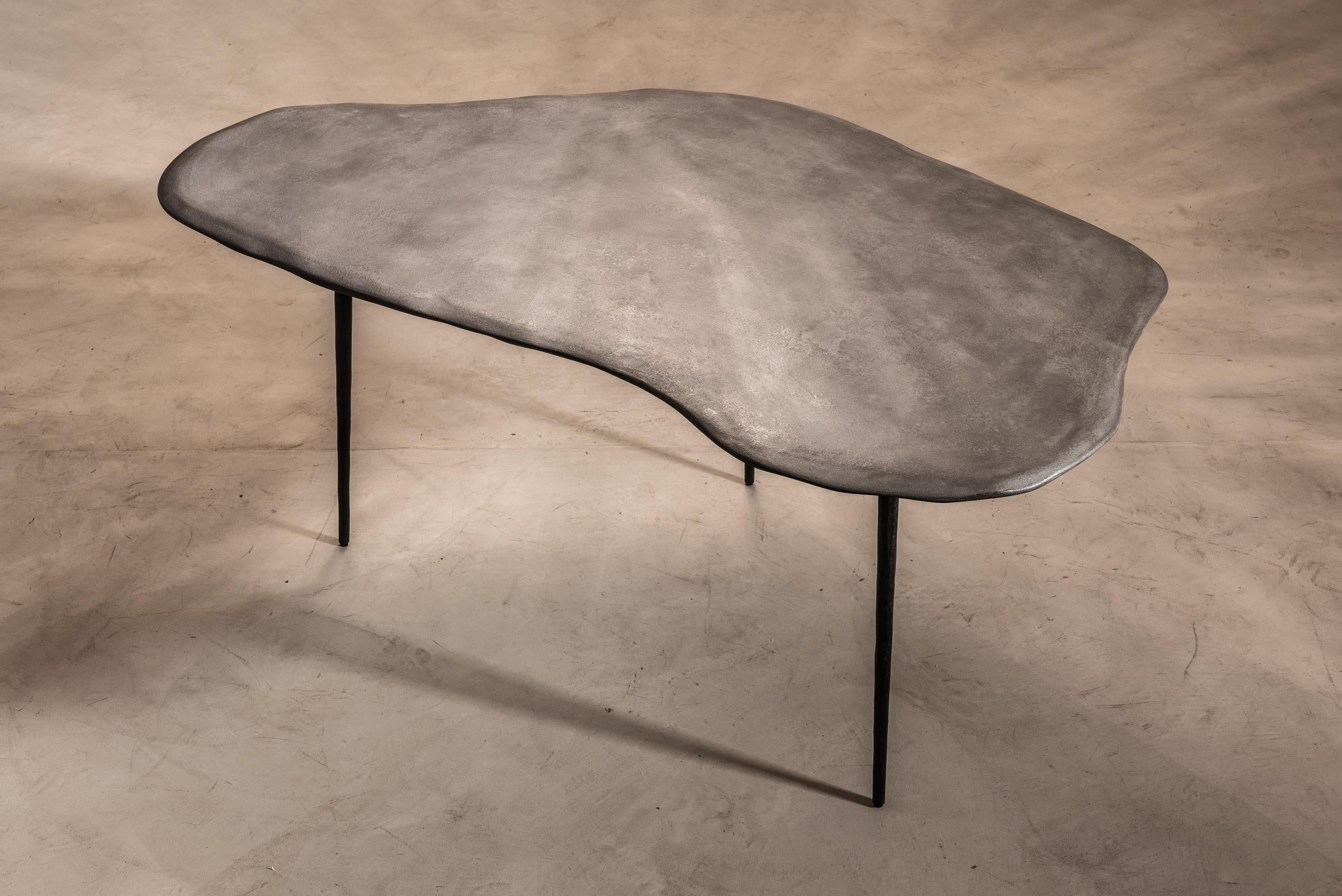 Varenna table C by Studio Emblématique.
Dimensions: W 157 x D 92 x H 76 cm.
Materials: Stonegrain tabletop with conical metal hammered legs.

Pushing the boundaries, going the extra mile to find the extraordinary piece that defines the space.